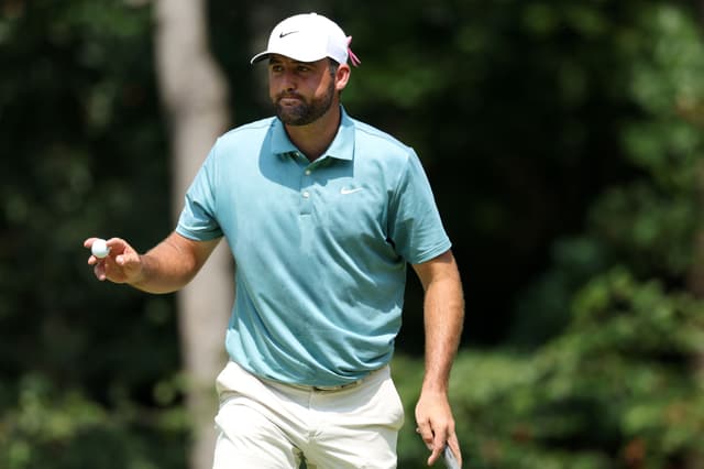 Scottie Scheffler of the United States reacts to his putt on the first green during the final round
