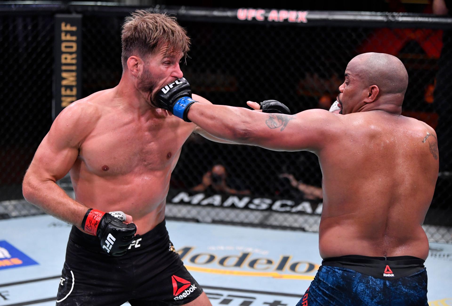 Daniel Cormier punches Stipe Miocic in their UFC heavyweight championship