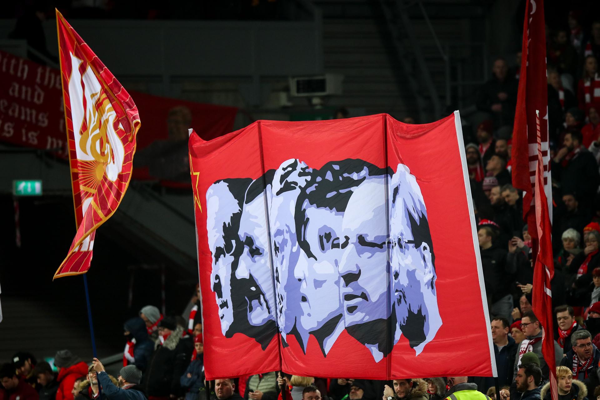  Fans of Liverpool hold up a banner of past managers during the Premier League match