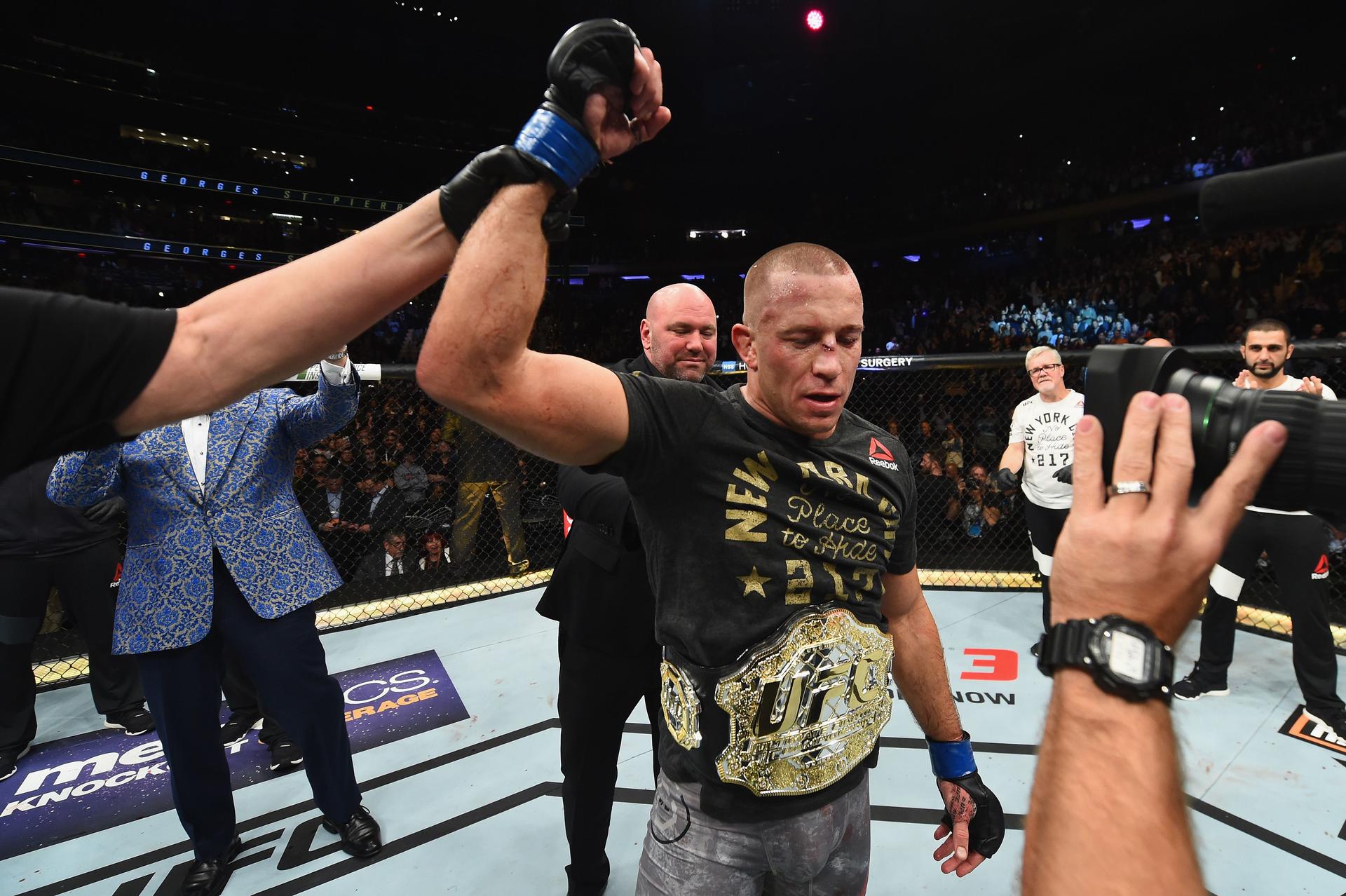 Georges St-Pierre of Canada celebrates with his championship belt