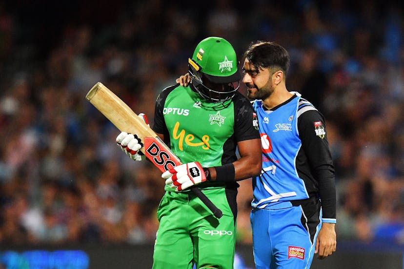 Dwayne Bravo of the Melbourne Stars talks with Rashid Khan of the Adelaide Strikers