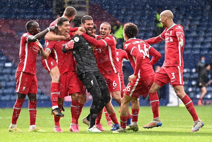 Alisson Becker of Liverpool is congratulated by Sadio Mane, Roberto Firmino