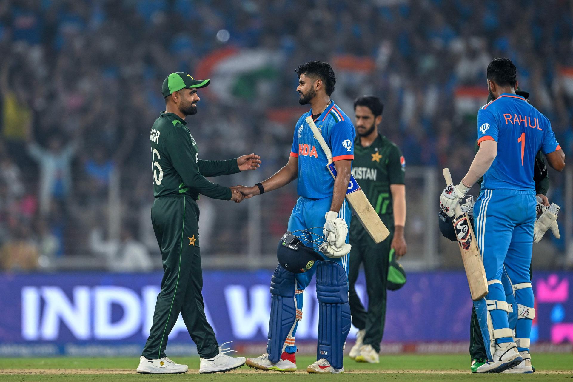 India's Shreyas Iyer (C) and KL Rahul (R) shake hands with Pakistan