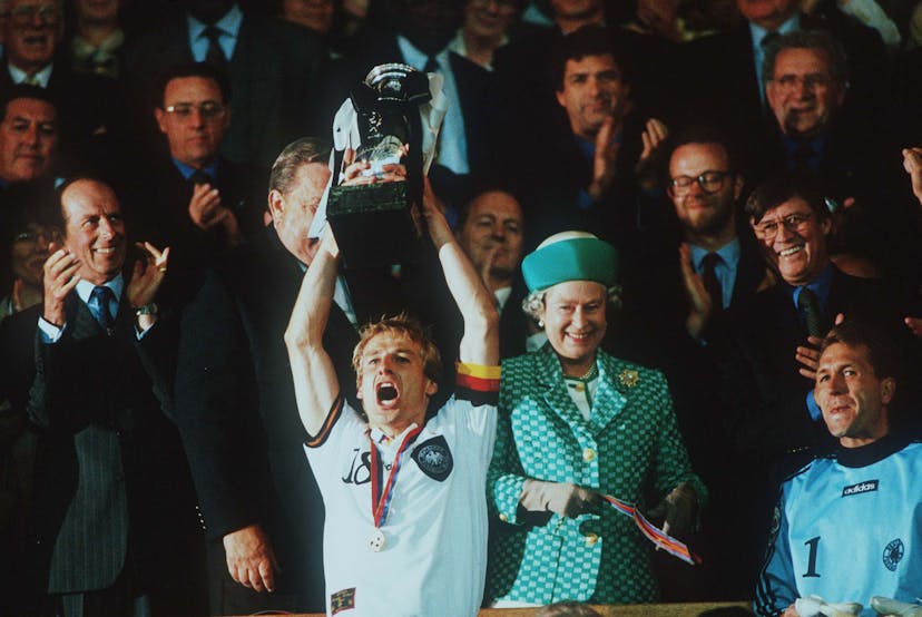 Queen Elizabeth II watches Jurgen Klinsmann of Germany celebrate by Lifting the Euro Cup
