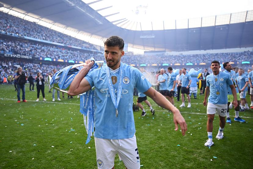 Ruben Dias of Manchester City celebrates with The Premier League Trophy after the Premier League match between Manchester City and West Ham United at Etihad Stadium