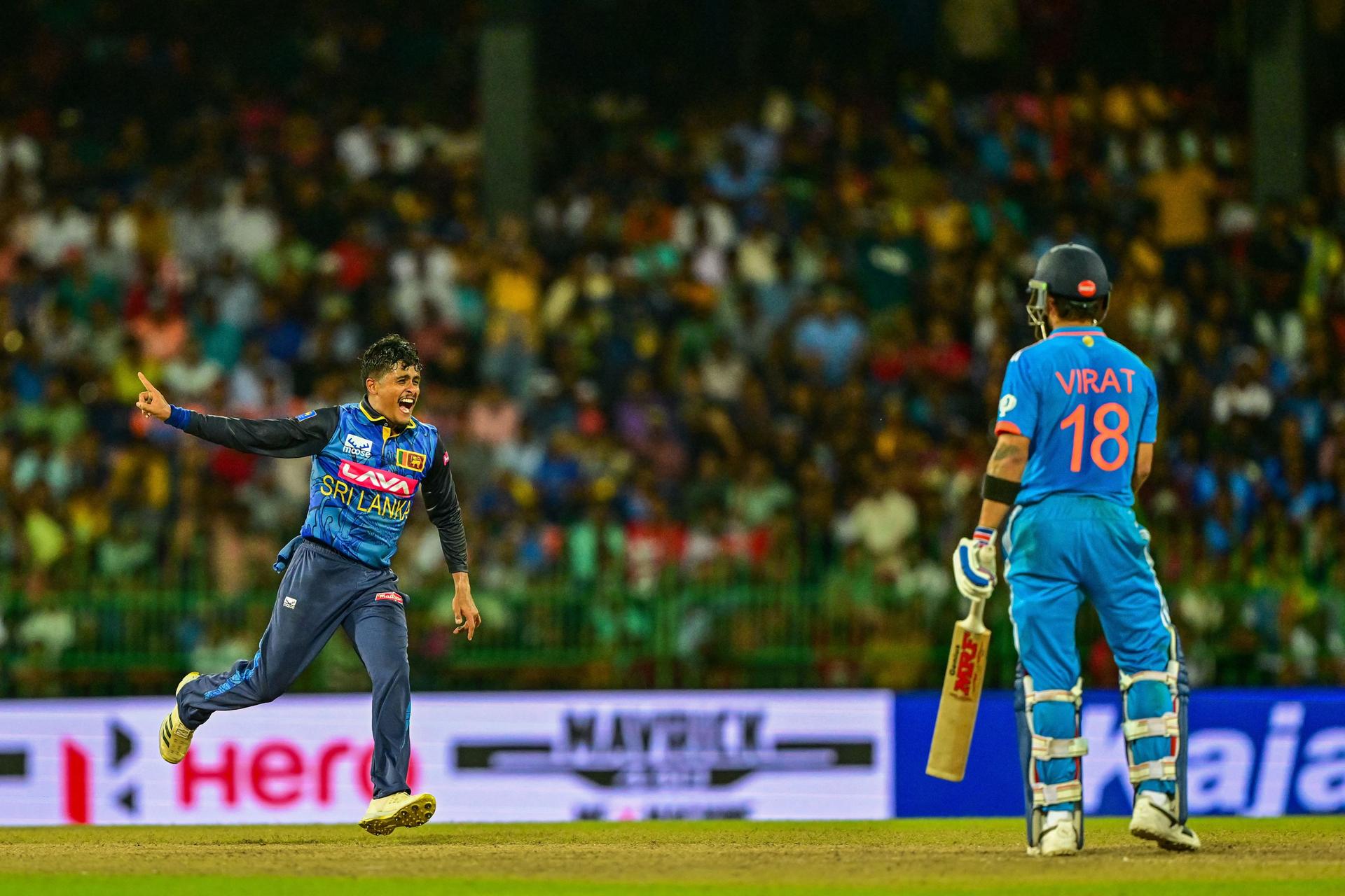 Sri Lanka's Jeffrey Vandersay (L) celebrates with teammates after taking the wicket of India's Virat Kohli 