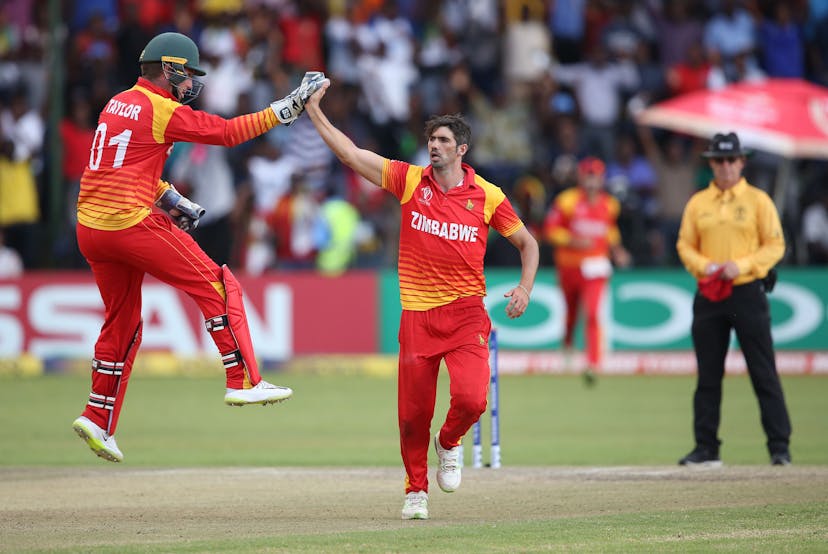 Brendan Taylor (L) and Graeme Cremer of Zimbabwe celebrate the wicket of Shimron Hetmyer of The West Indies during The Cricket World Cup Qualifier 