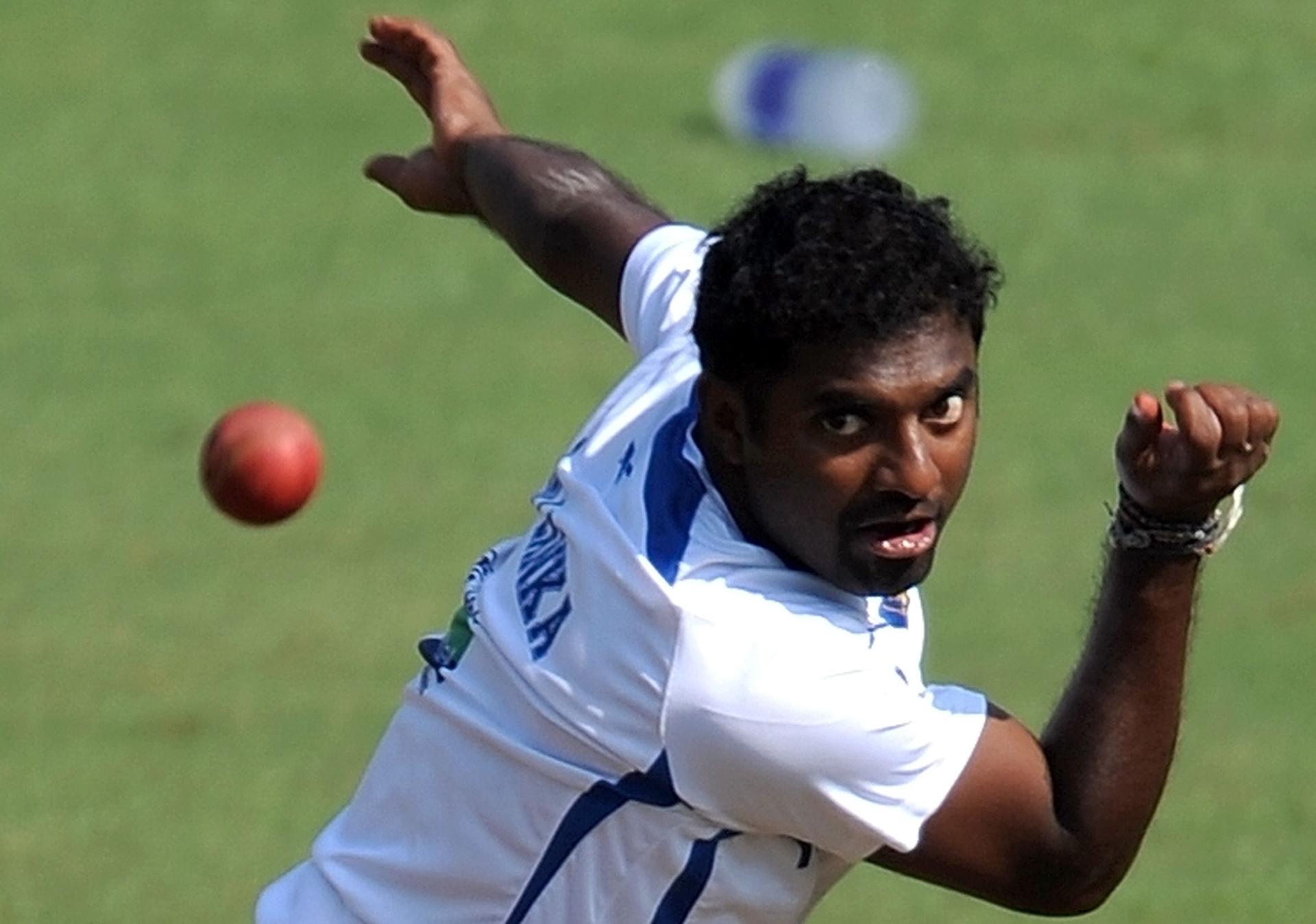 Sri Lankan cricketer Muttiah Muralitharan bowls 