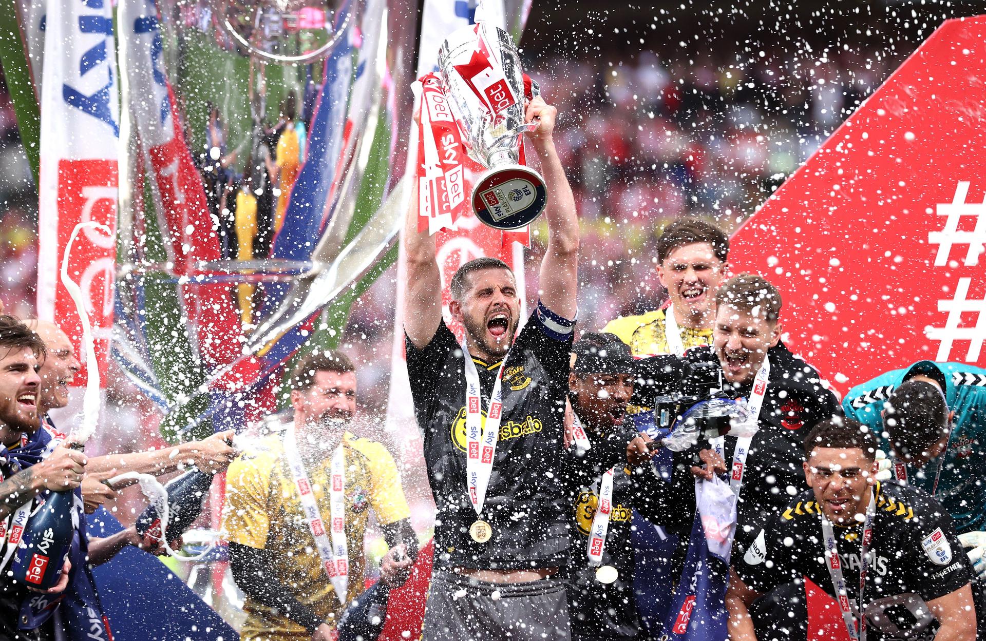 Jack Stephens lifts the trophy