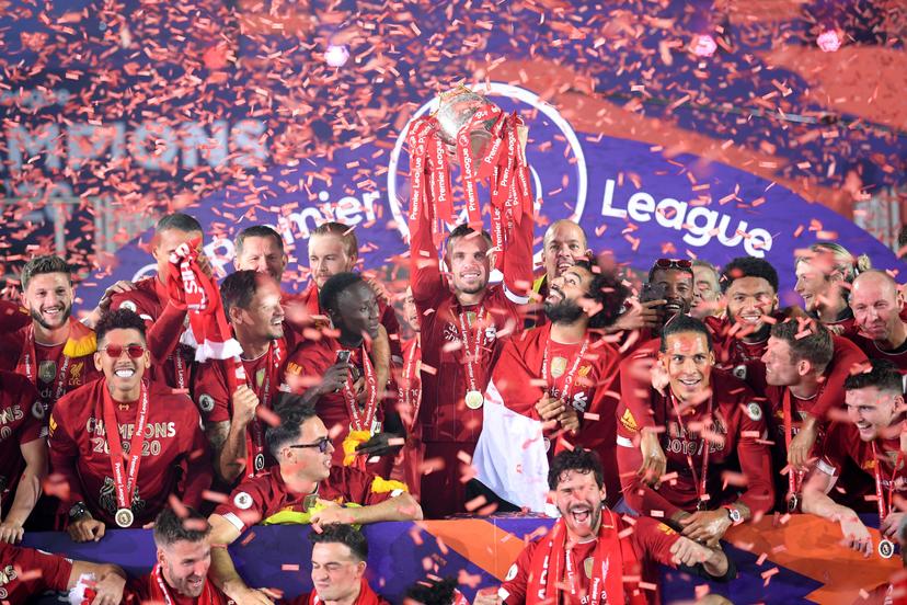 Jordan Henderson of Liverpool holds the Premier League Trophy