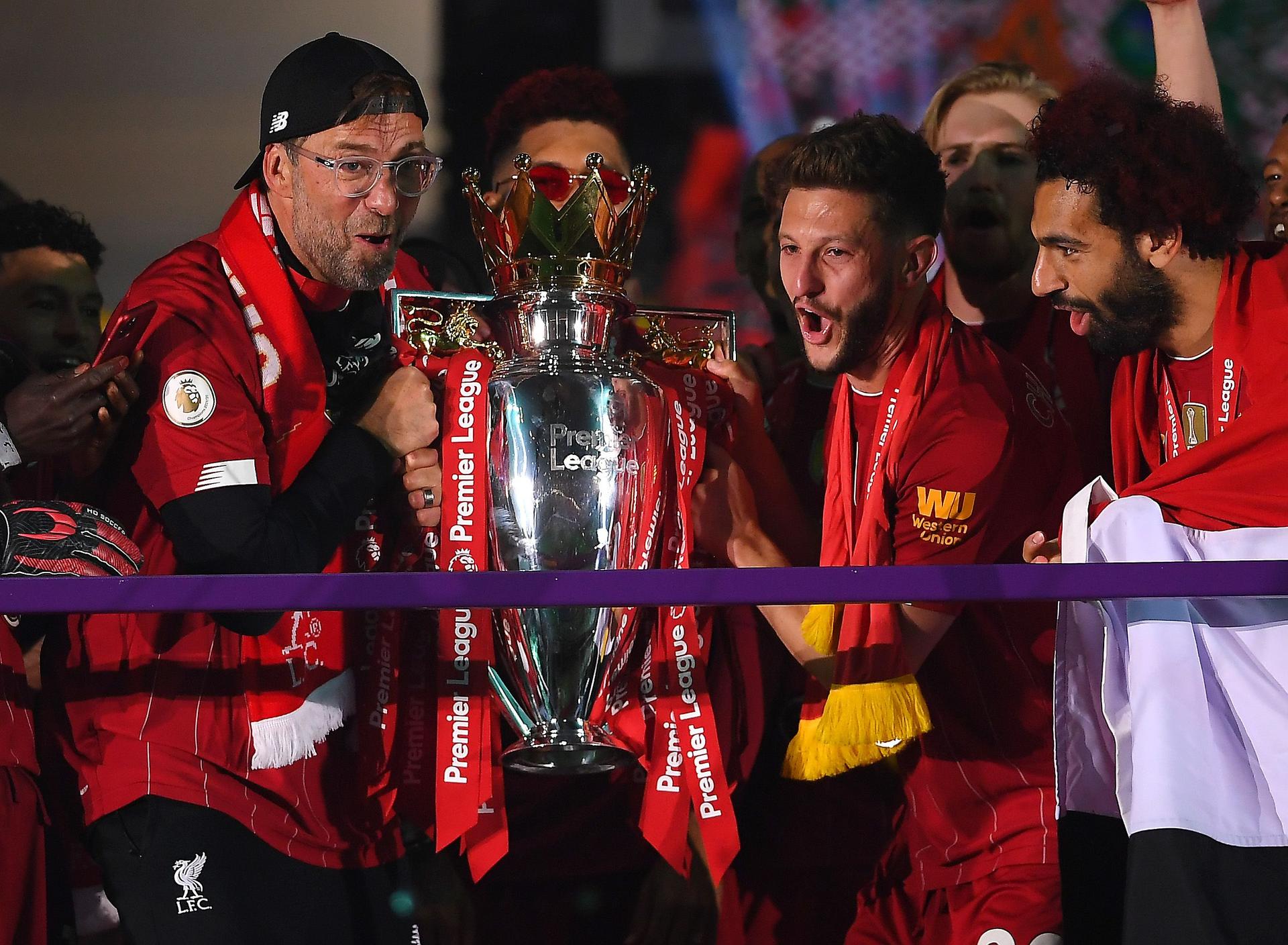 Jurgen Klopp, Adam Lallana and Mohamed Salah of Liverpool holds the Premier League Trophy