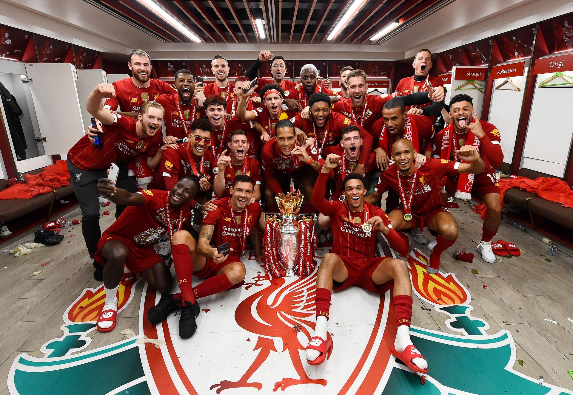 Liverpool celebrating in the dressing room with the premier league trophy