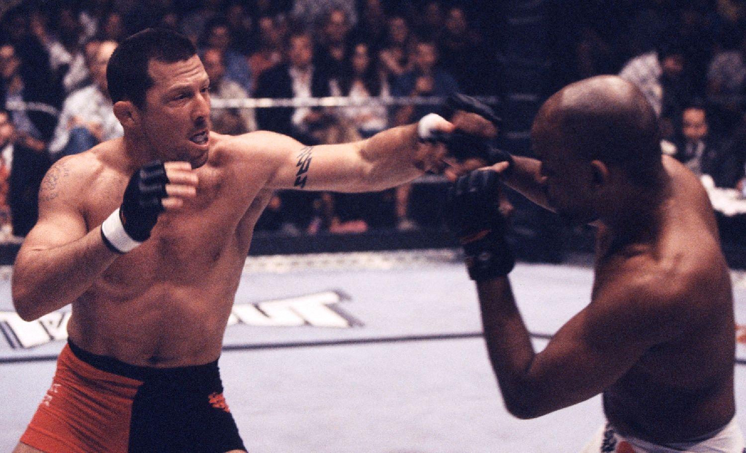 Pat Miletich punches Shonie Carter during their bout at UFC 32 