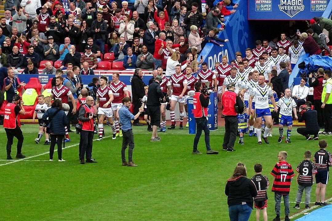 Super League clubs, Wigan and Warrington, walk out at Magic Weekend.jpg