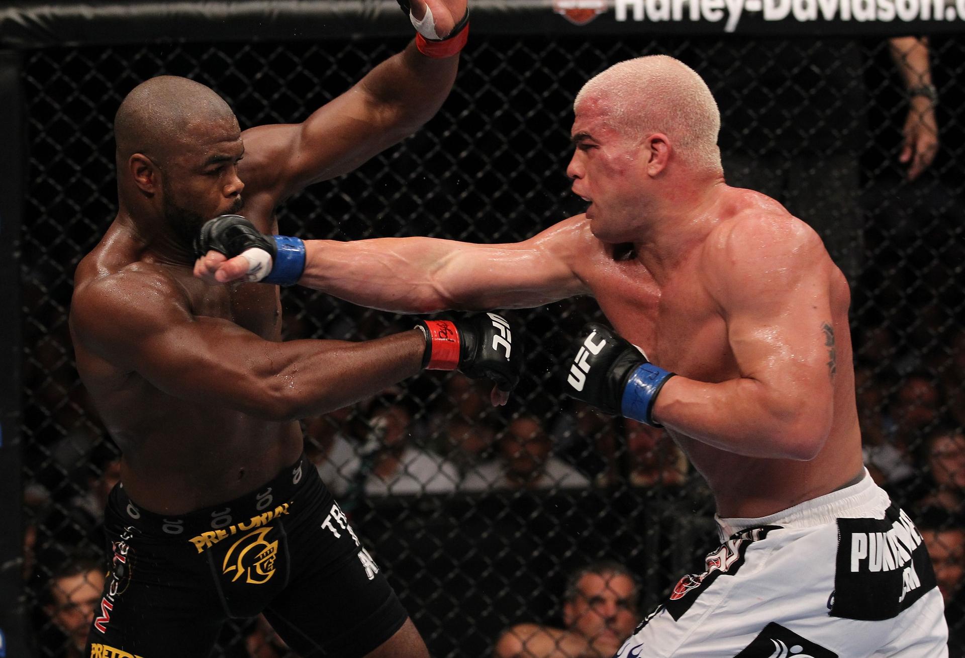 Tito Ortiz (white shorts) punches Rashad Evans.jpg