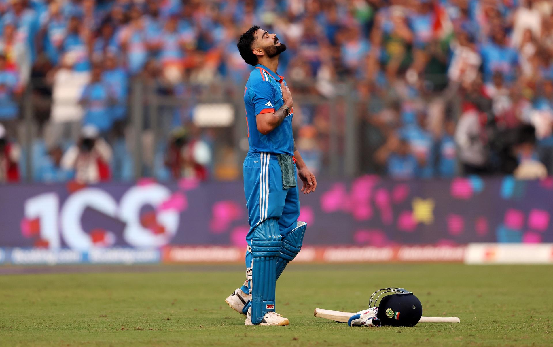 Virat Kohli celebrates after scoring a century