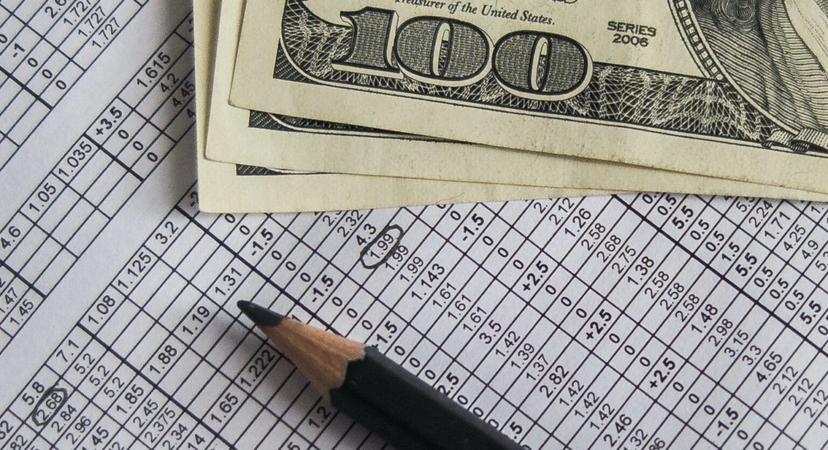 A scoresheet, money, and a pencil