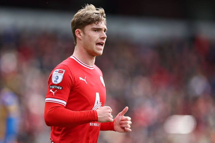 Footballer Luca Connell in English League One match in Barnsley kit 