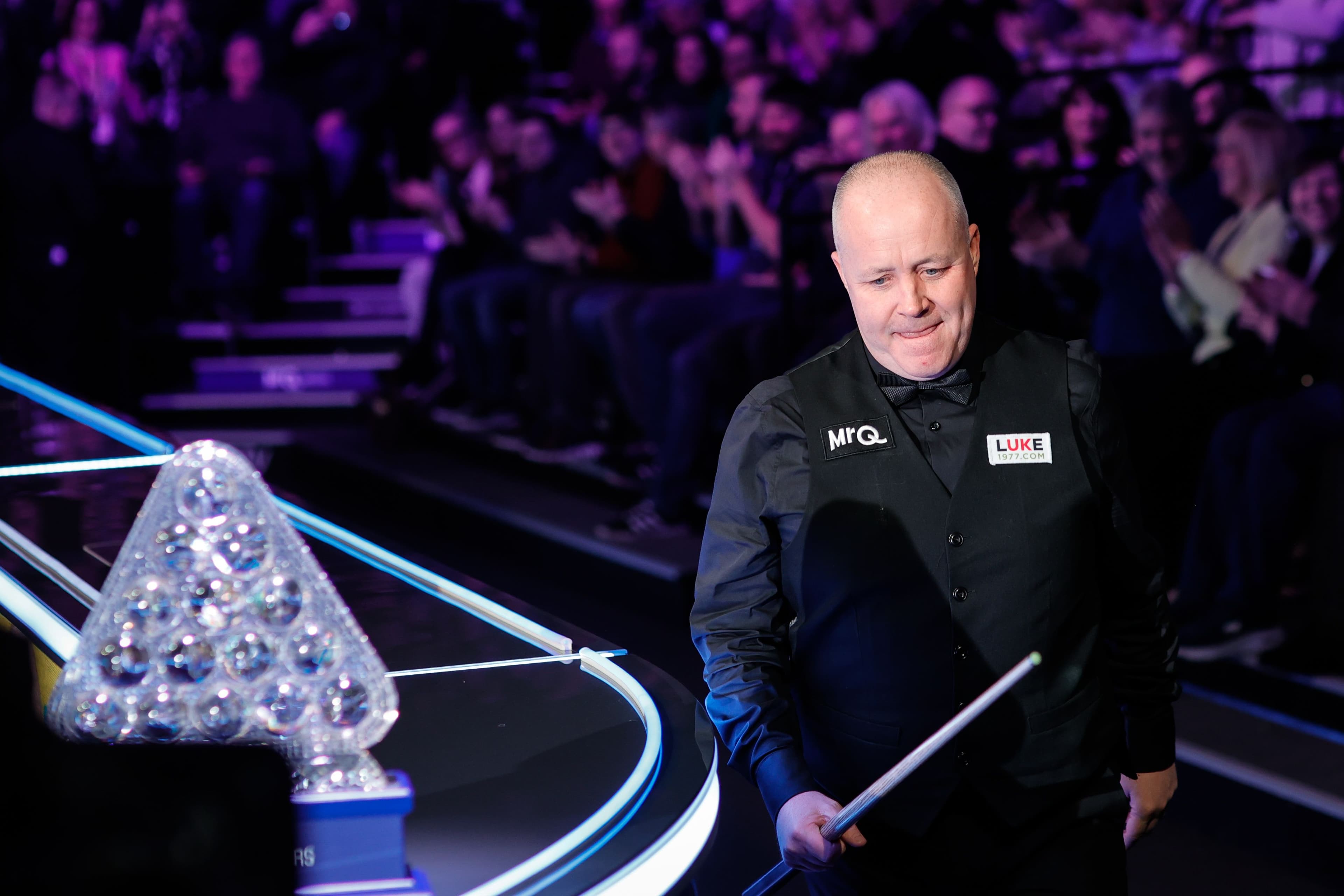 Snooker player next to a trophy