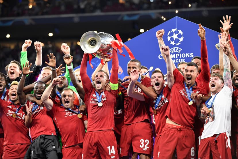 Jordan Henderson of Liverpool FC lifts the trophy with his teammates as they celebrate winning the UEFA Champions League Final