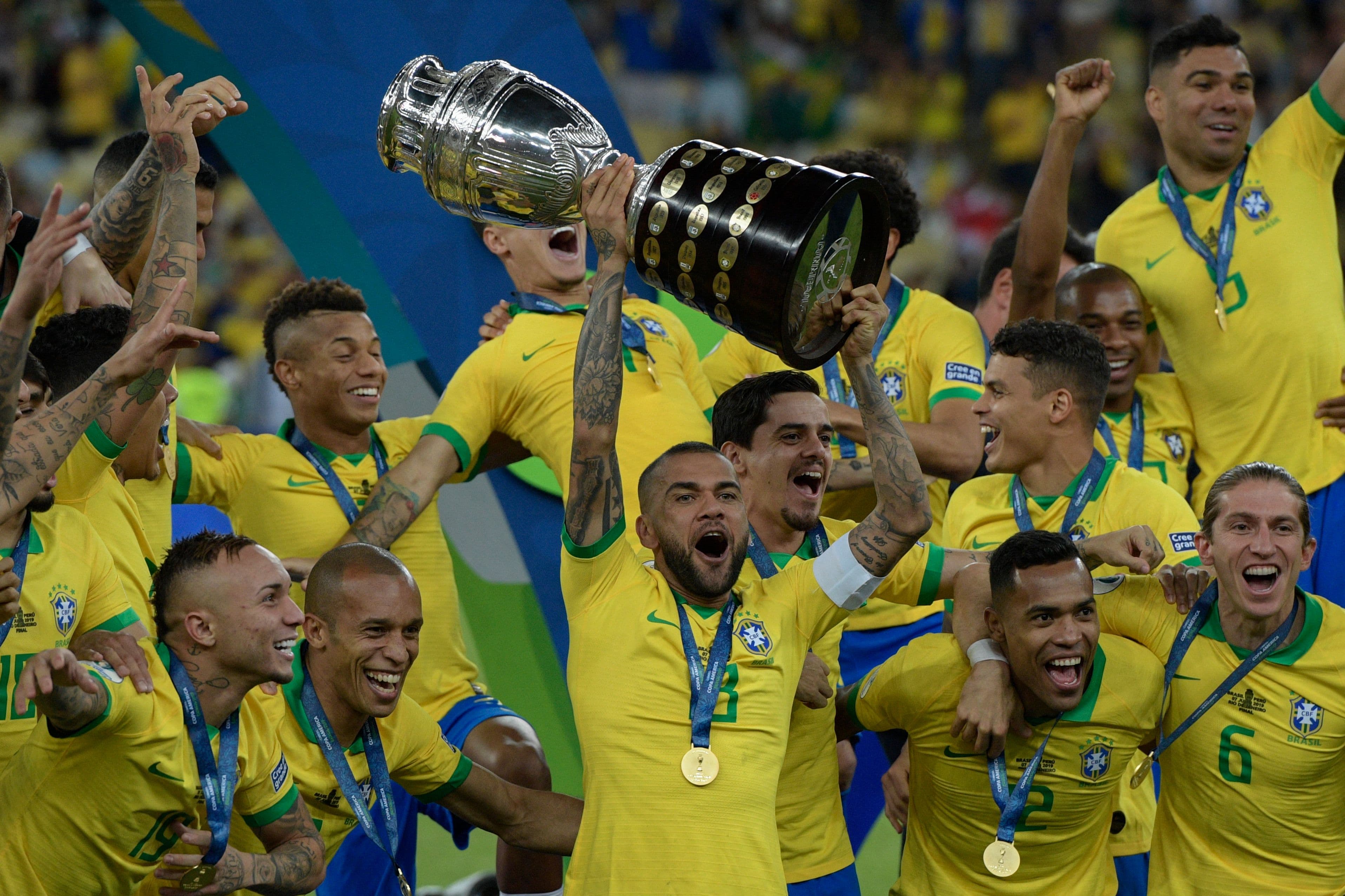 Brazil's Dani Alves (C) and teammates celebrates with the trophy after winning the Copa America 