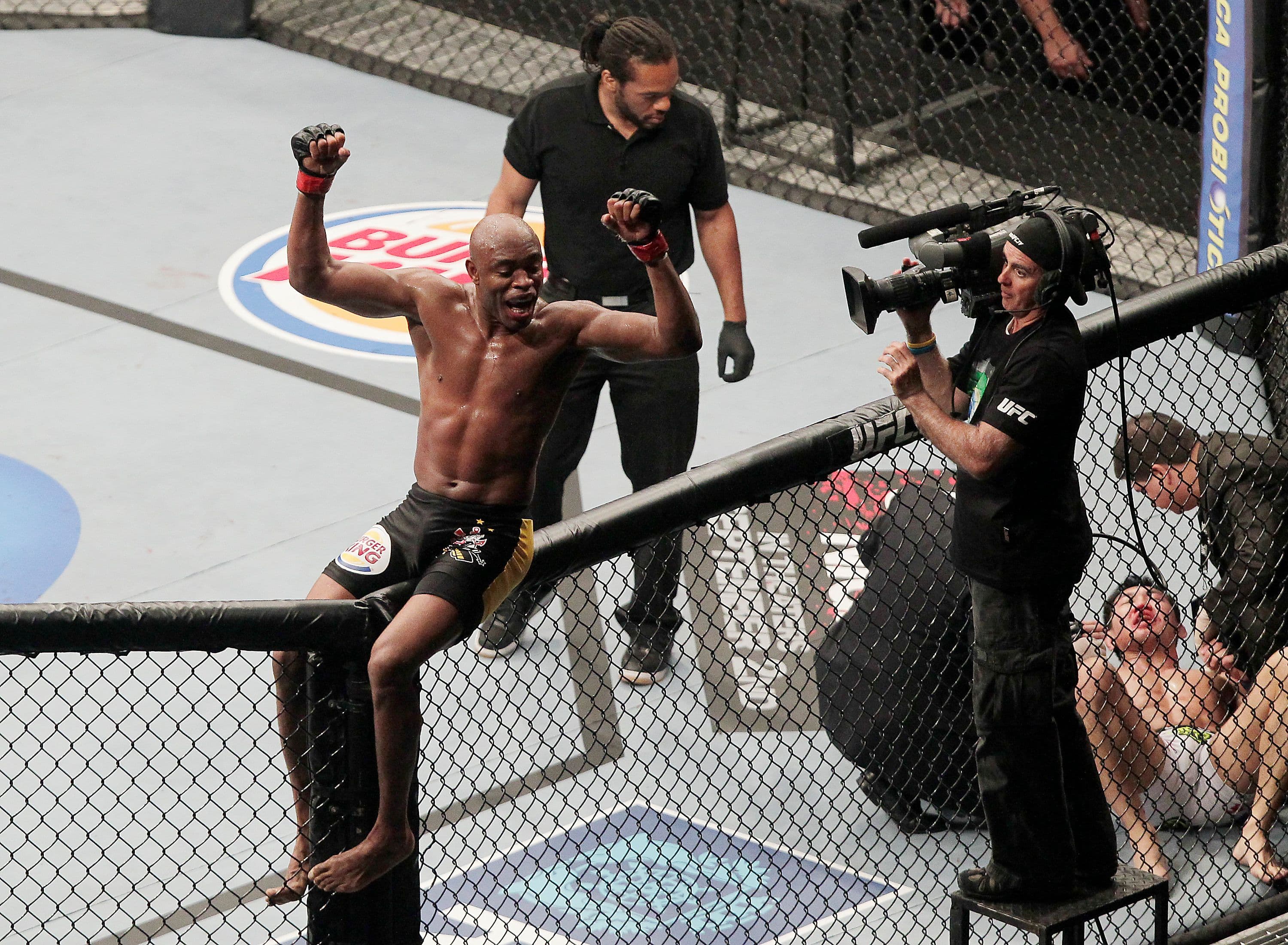 Anderson Silva (L) celebrates after defeating Yushin Okami