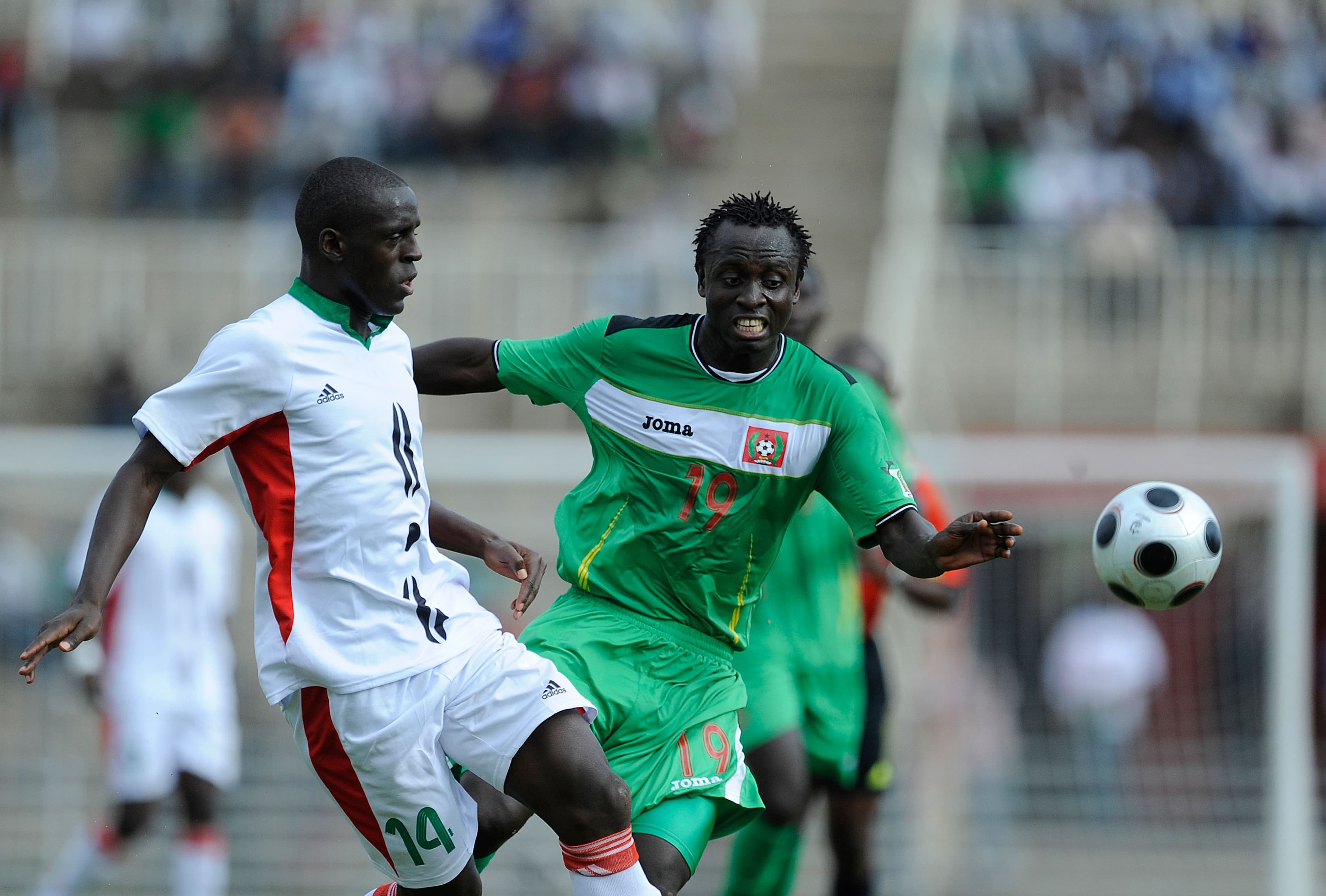 Guinea-Bisau's Bazil Carvahlo (R) vies for the ball against Kenya's James Situma 