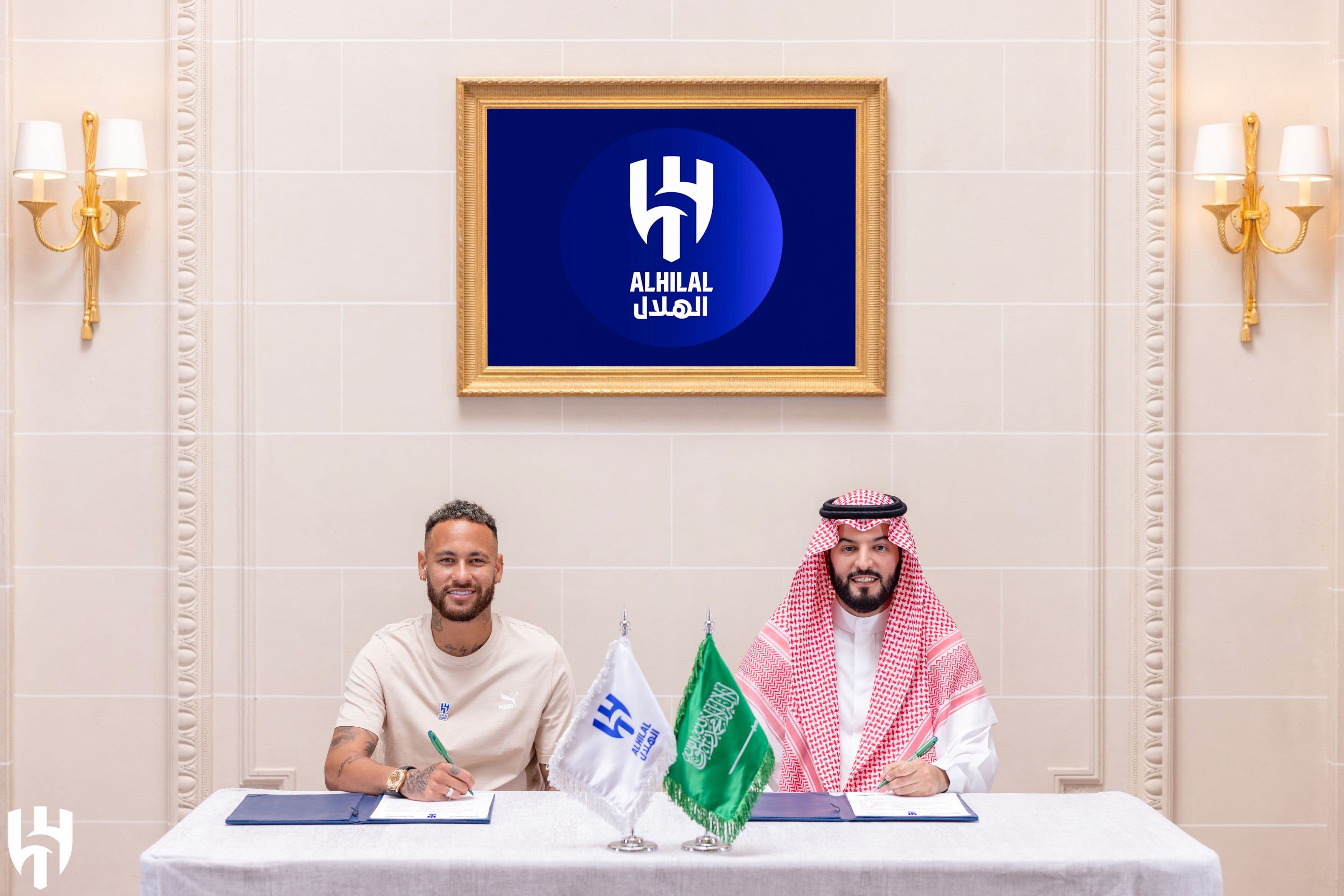 Brazilian football star Neymar (L) and Al-Hilal's president Fahad bin Nafel (R) 