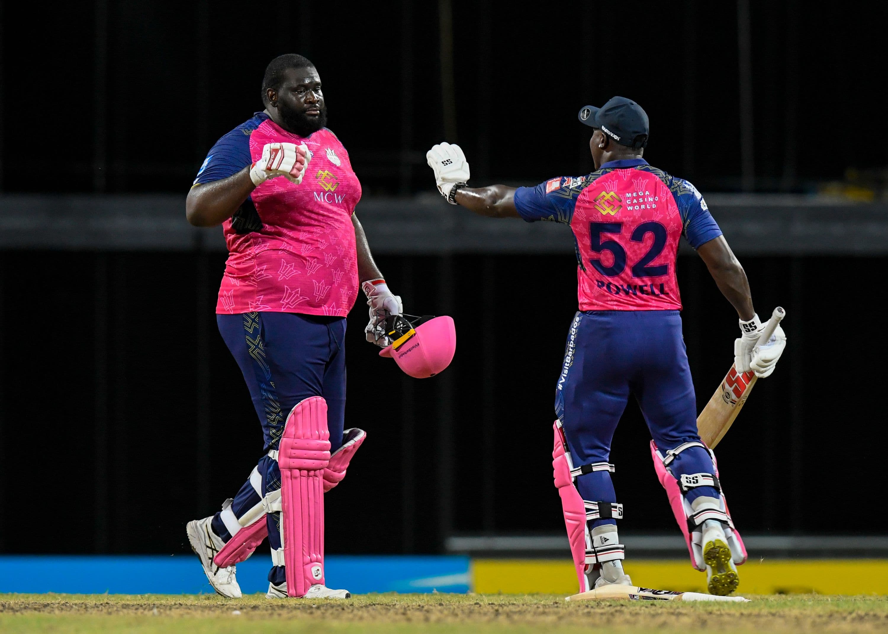 Rovman Powell (R) congratulate Rahkeem Cornwall of Barbados Royals on his century during the Men's 2023 Republic Bank Caribbean Premier League