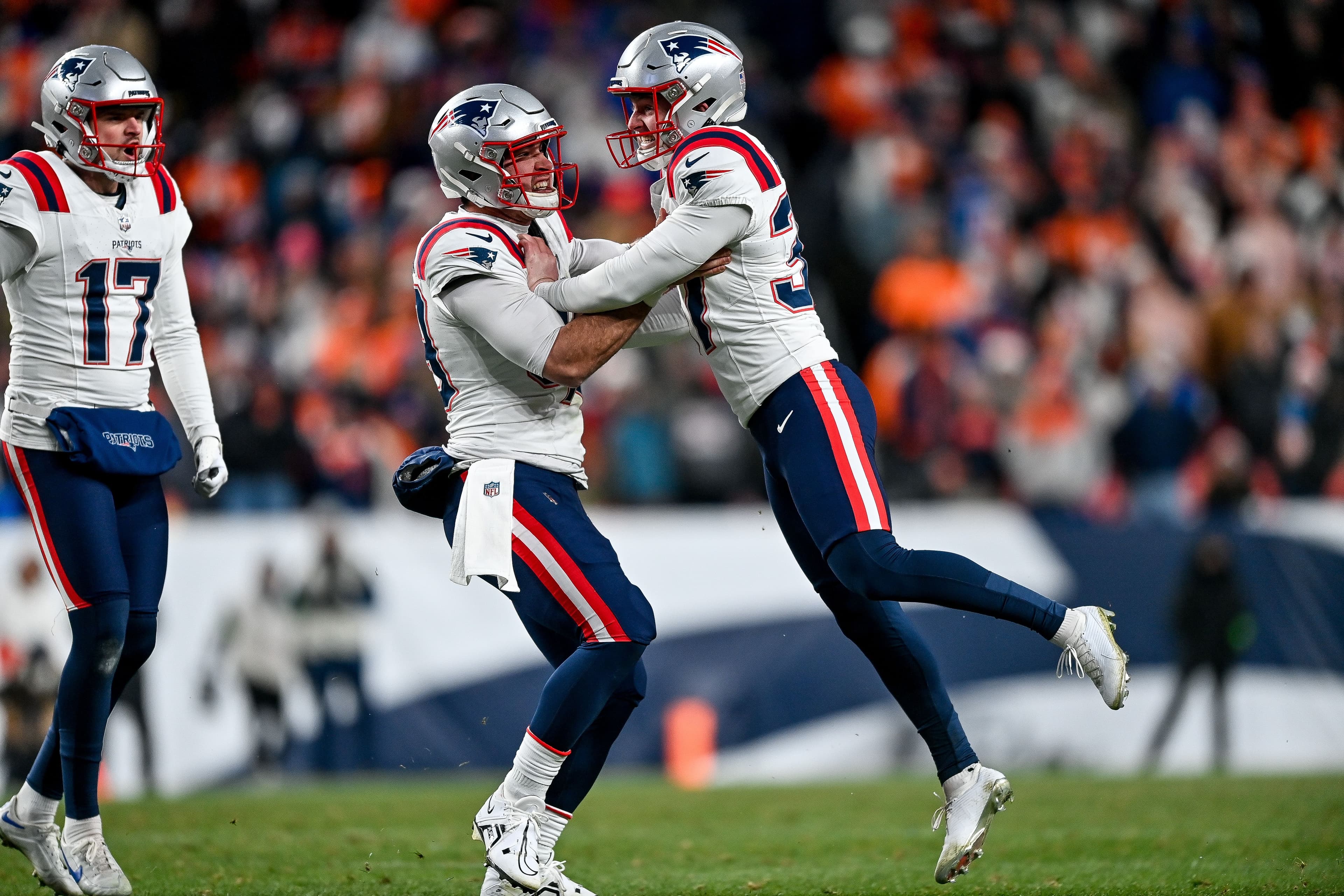  Chad Ryland #37, Joe Cardona #49, and Bryce Baringer #17 of the New England Patriots celebrate 