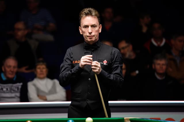 Ken Doherty of Ireland chalks the cue in the second 