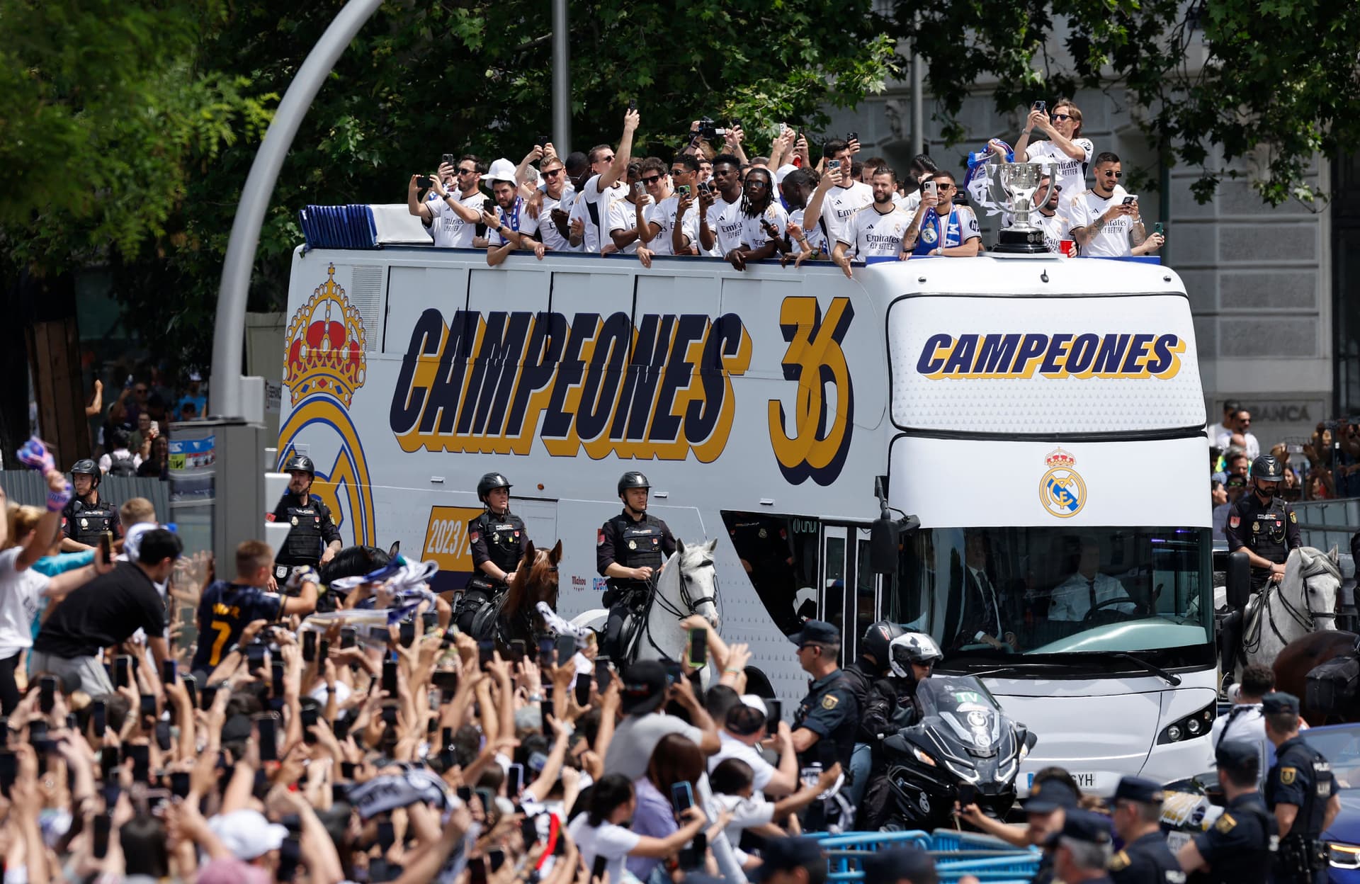 Real Madrid players parade onboard a bus as they celebrate their 36th La Liga