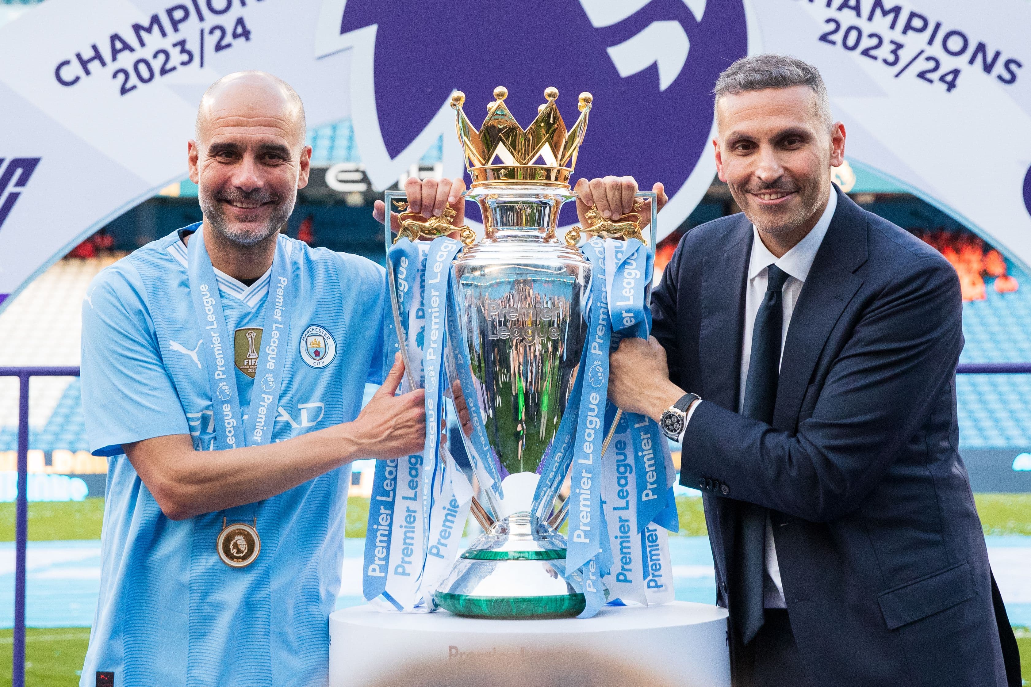 Khaldoon Al Mubarak chairman of Manchester City poses for a photo with the trophy with Pep Guardiola the head coach