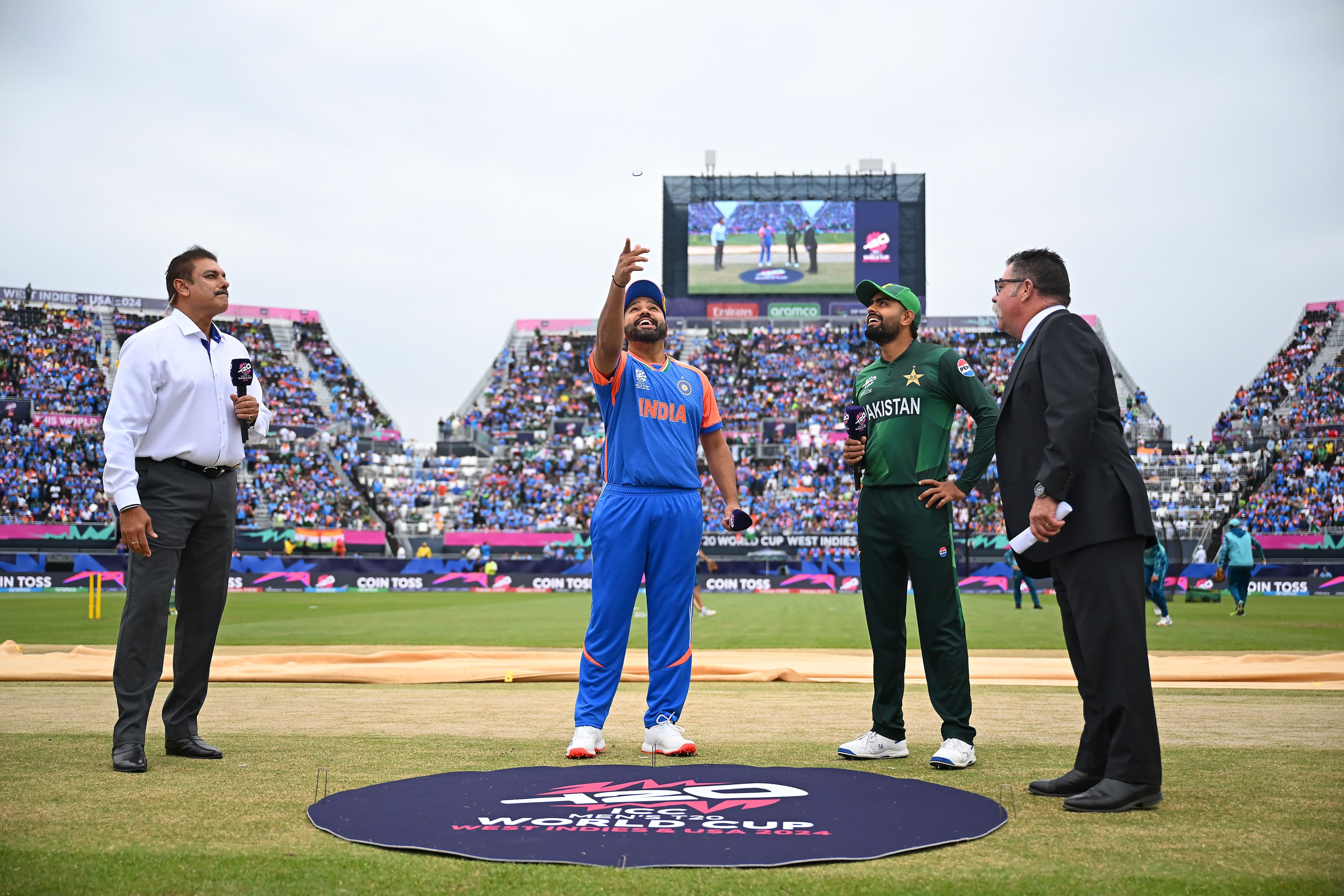 The coin toss takes place with Rohit Sharma of India 