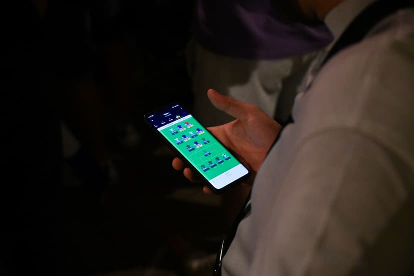 A fan of the French soccer team watches an online sports betting 