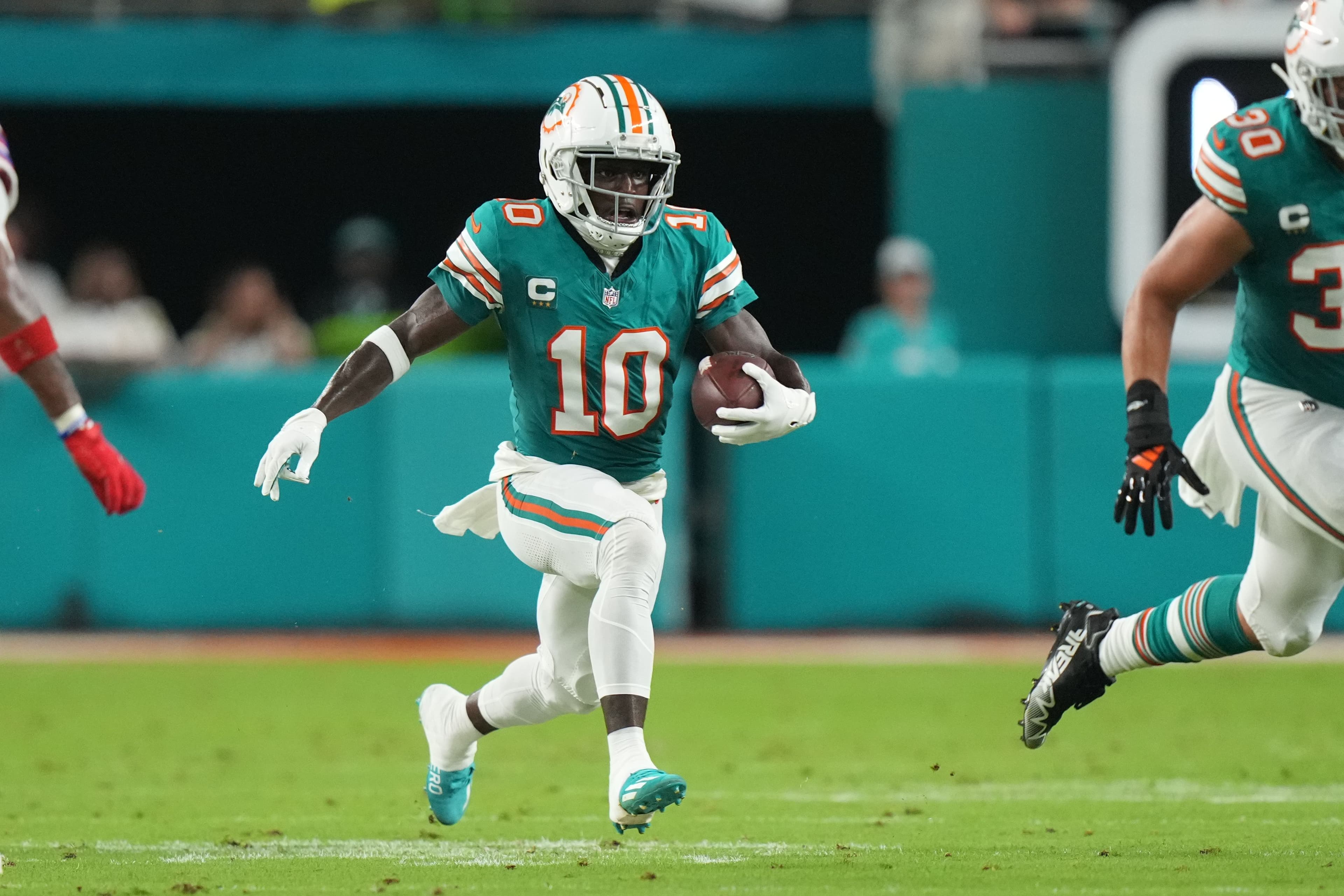 Miami Dolphins wide receiver Tyreek Hill (10) runs after a catch 