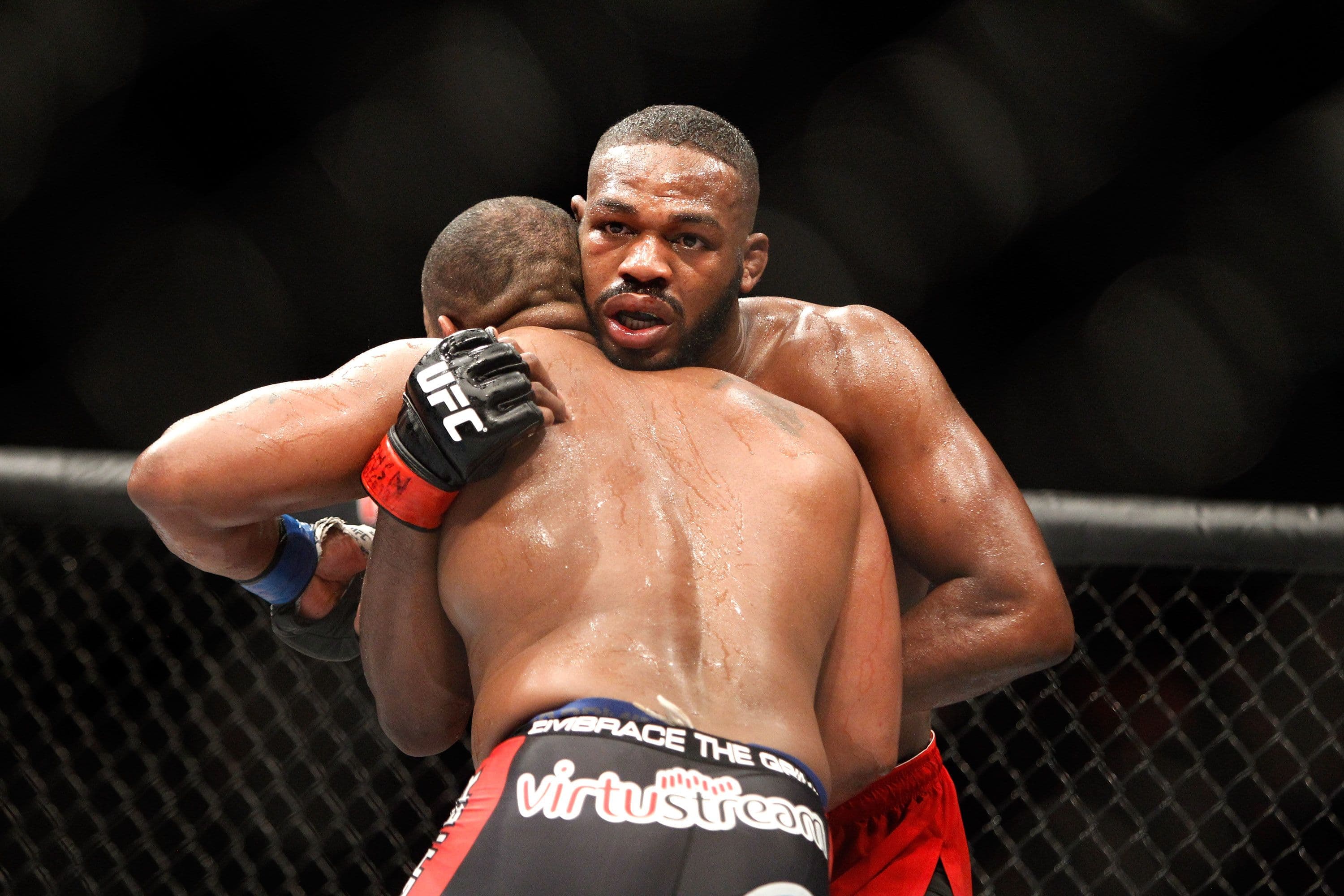  Light heavyweight champion Jon Jones (R) grapples with Daniel Comier 