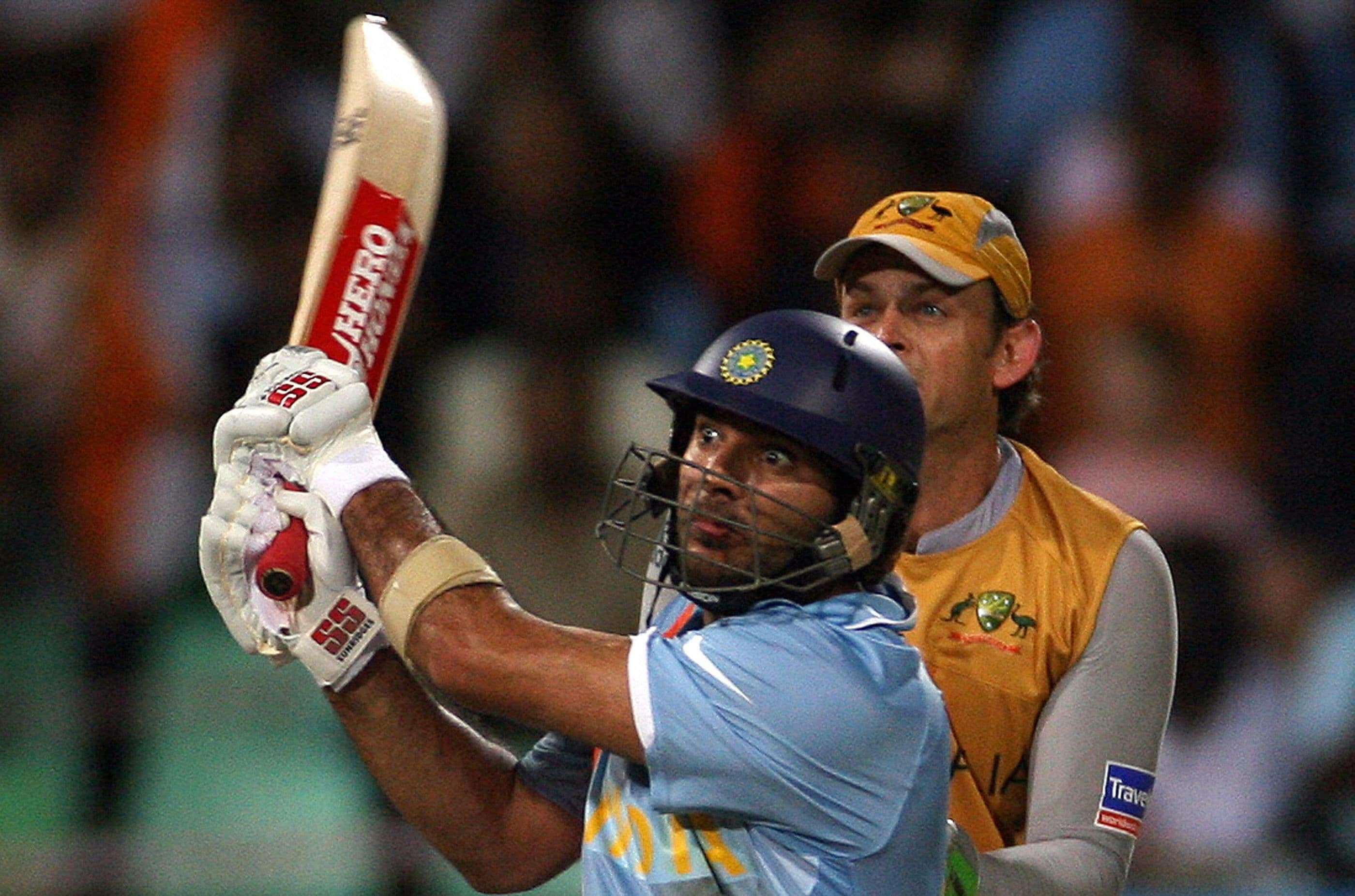 Indian cricket team batsman Yuvraj Singh plays for a long shot over the boundary for six runs as Australian wicketkeeper Adam Gilchrist (R) look on during the second semi-final of the ICC World Twenty20