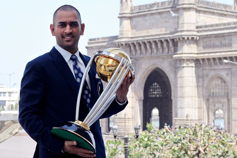 Mahendra Singh Dhoni poses with the ICC Cricket World Cup Trophy