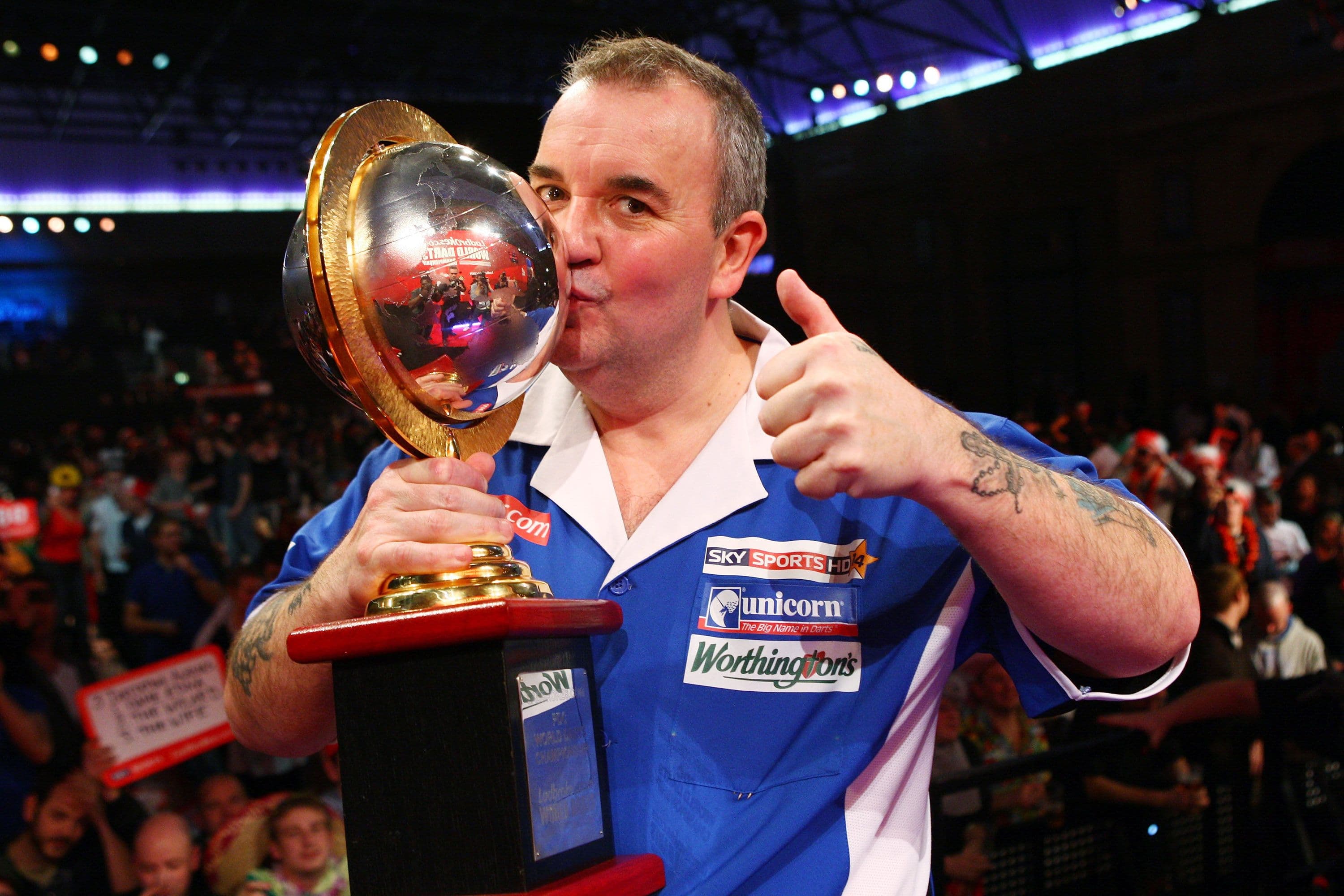 Phil Taylor of England poses with the trophy after winning the World title for a record fifteenth time