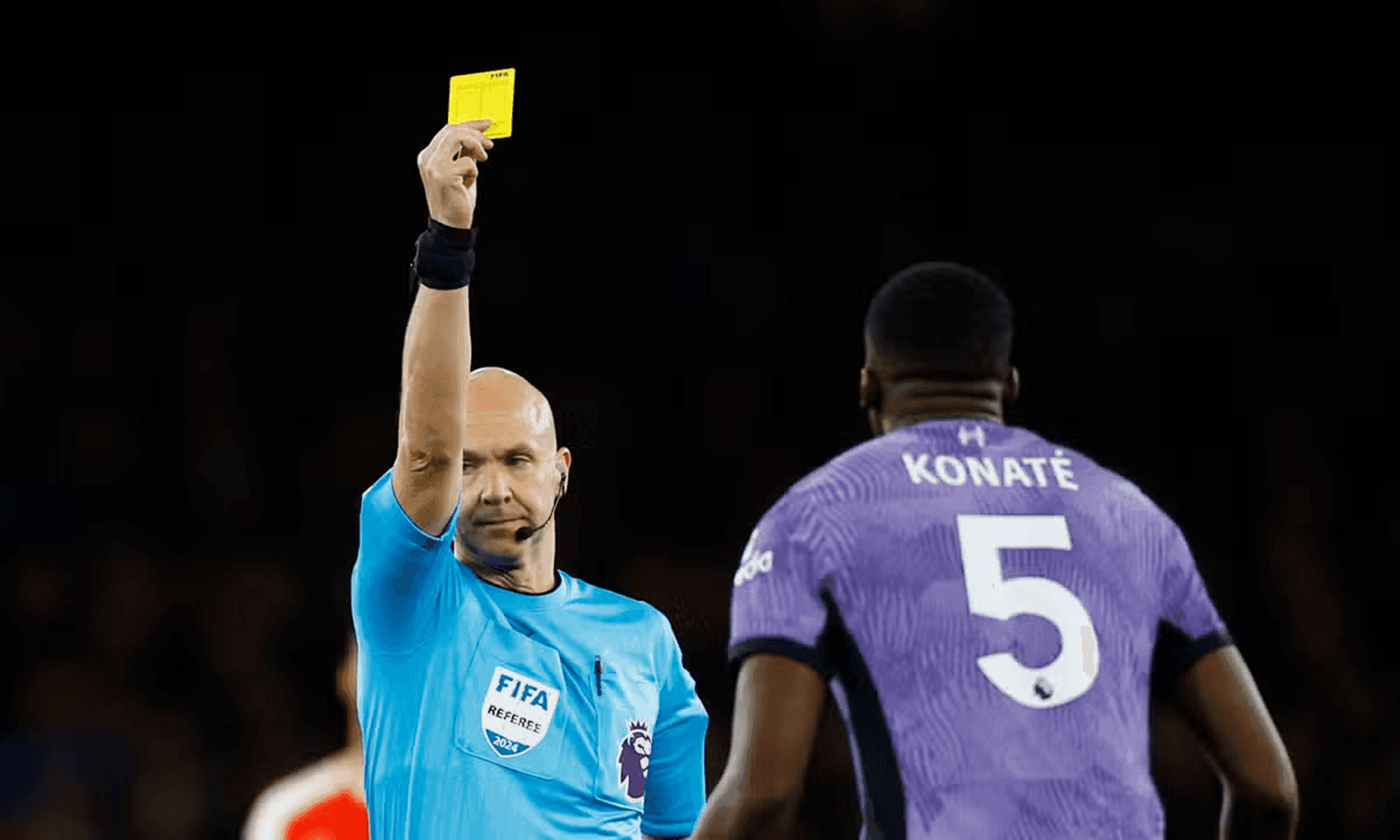 Ibrahima Konate being shown a yellow card during an EPL match.