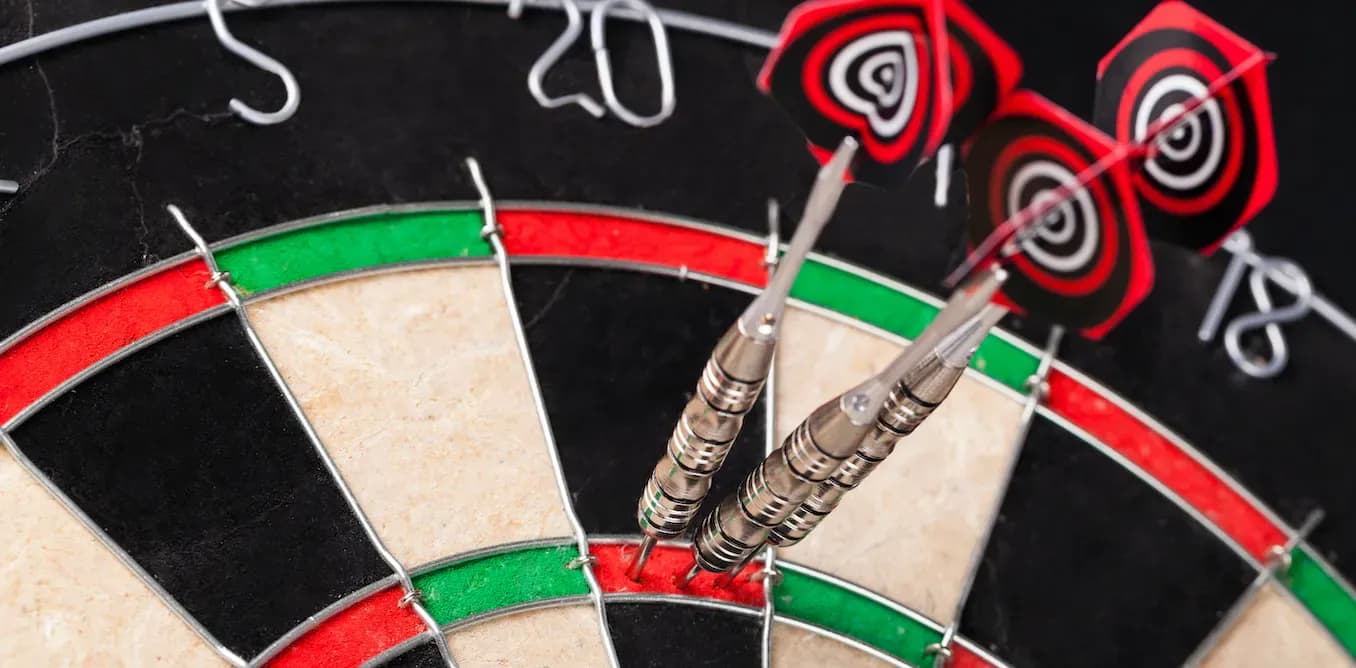 three darts on a board 