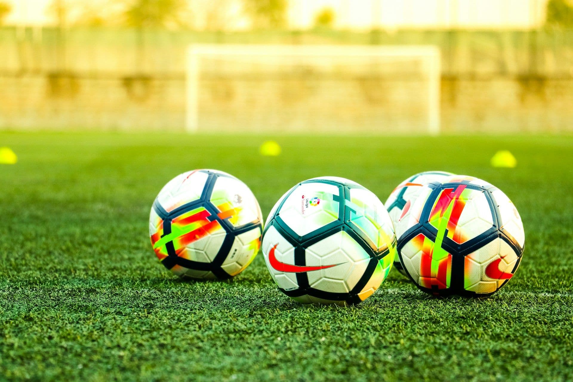 Footballs on a pitch