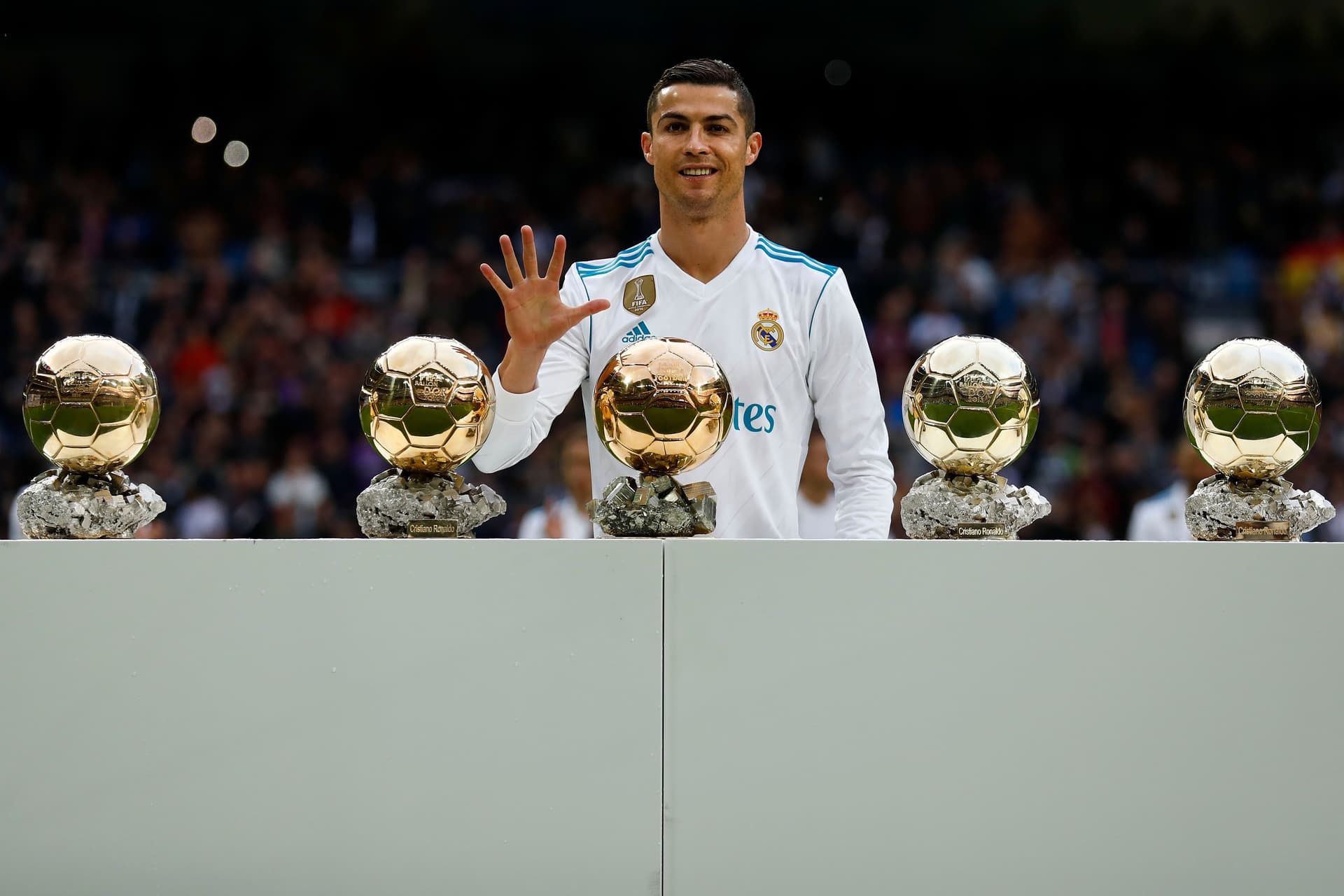 Cristiano Ronaldo poses with his five Golden Ball