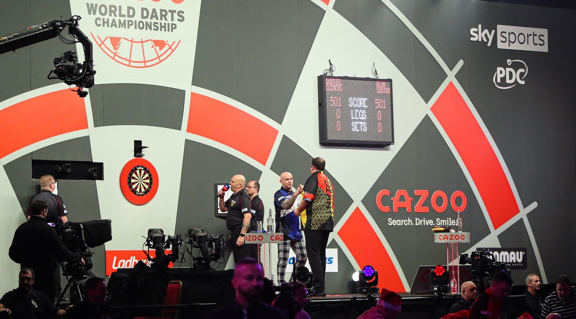 players on the darts stage