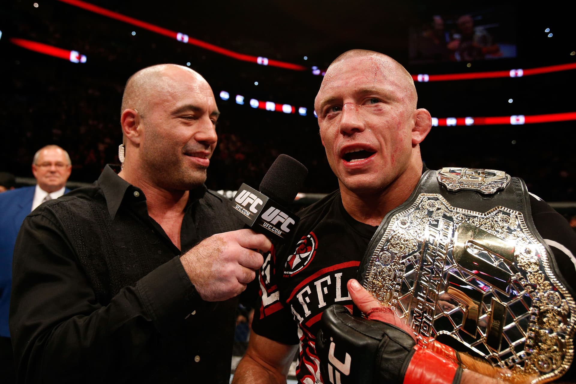 Georges St-Pierre (R) talks with Joe Rogan