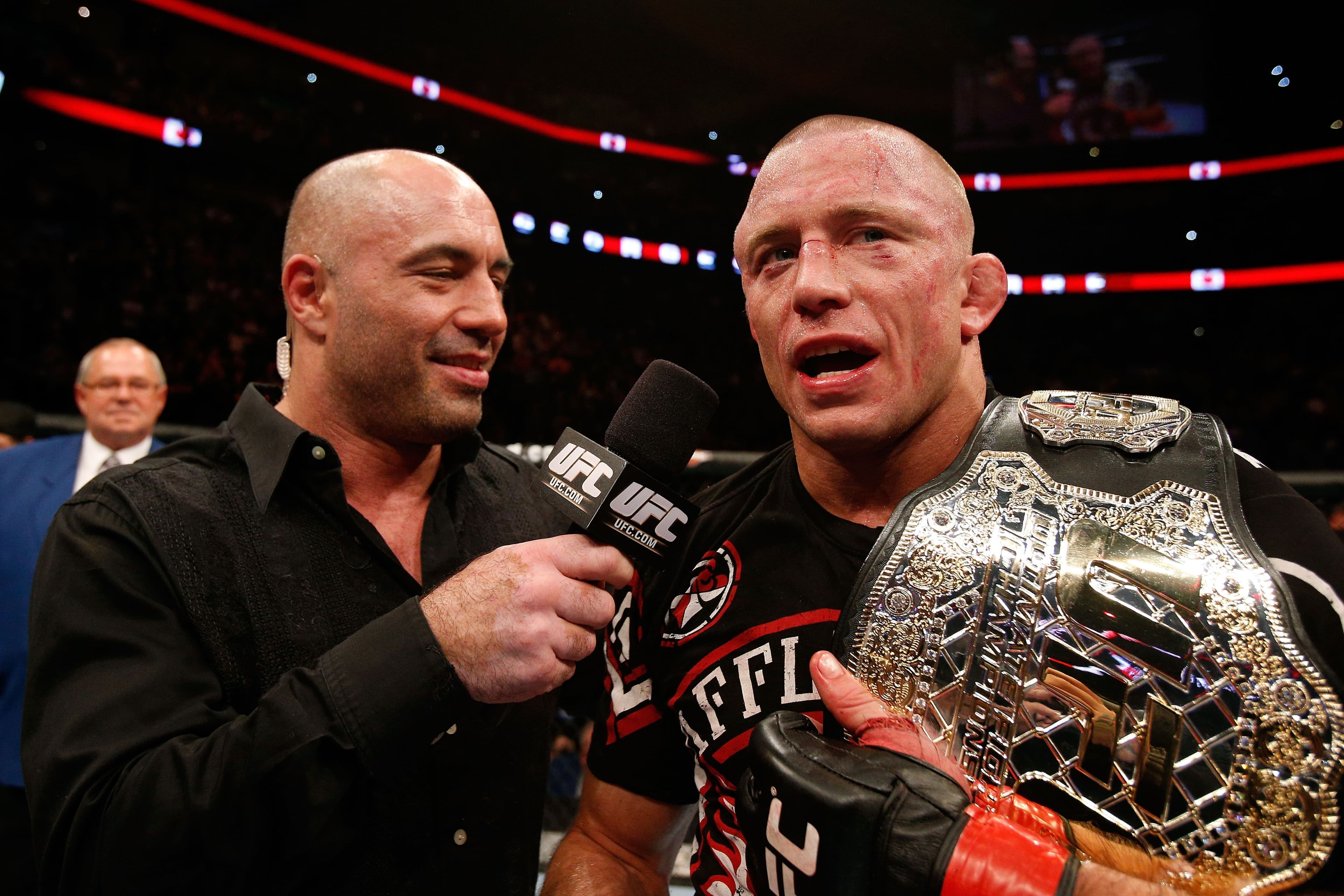 Georges St-Pierre (R) talks with Joe Rogan