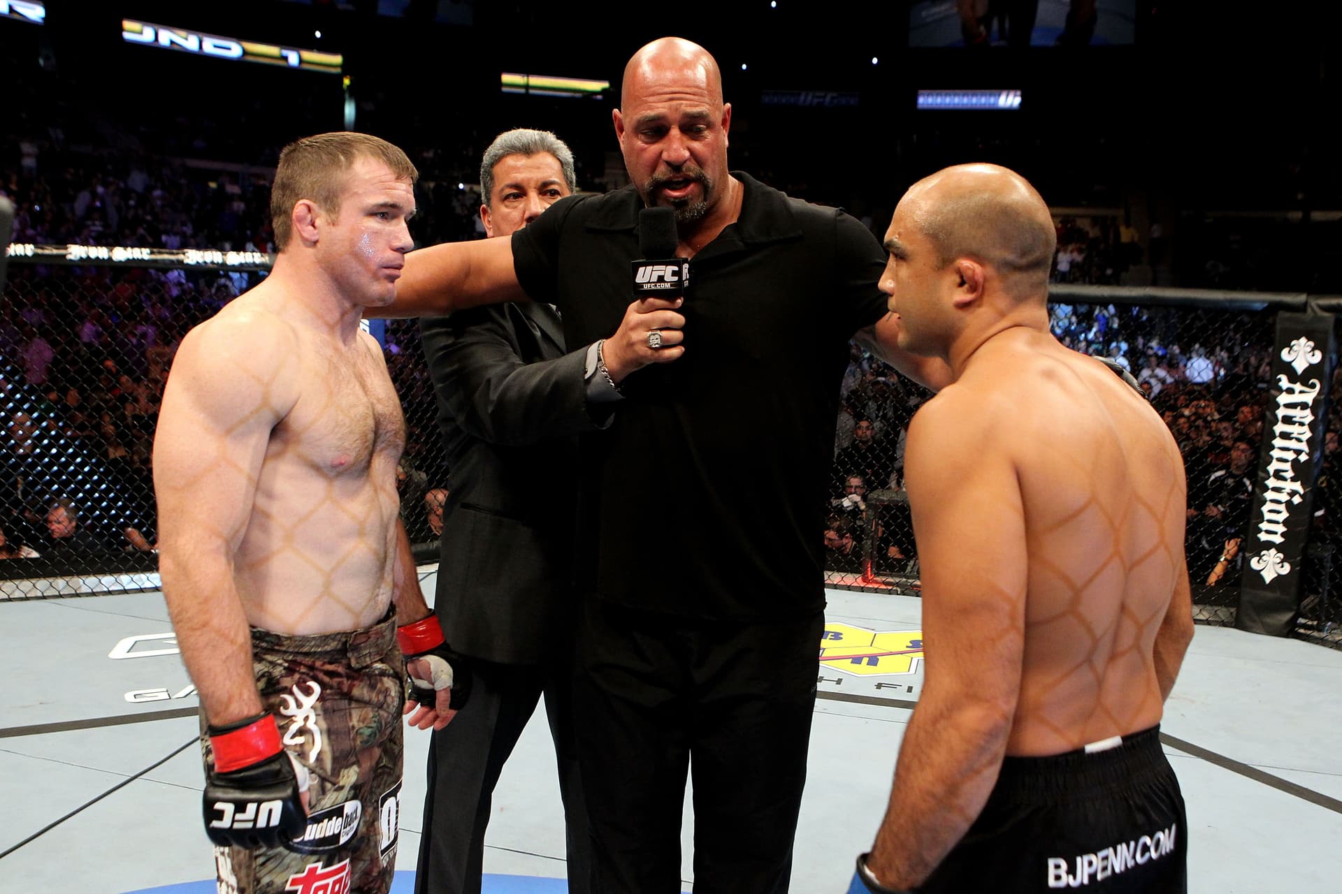 Matt Hughes (L) and BJ Penn (R) greet in the center of the octagon
