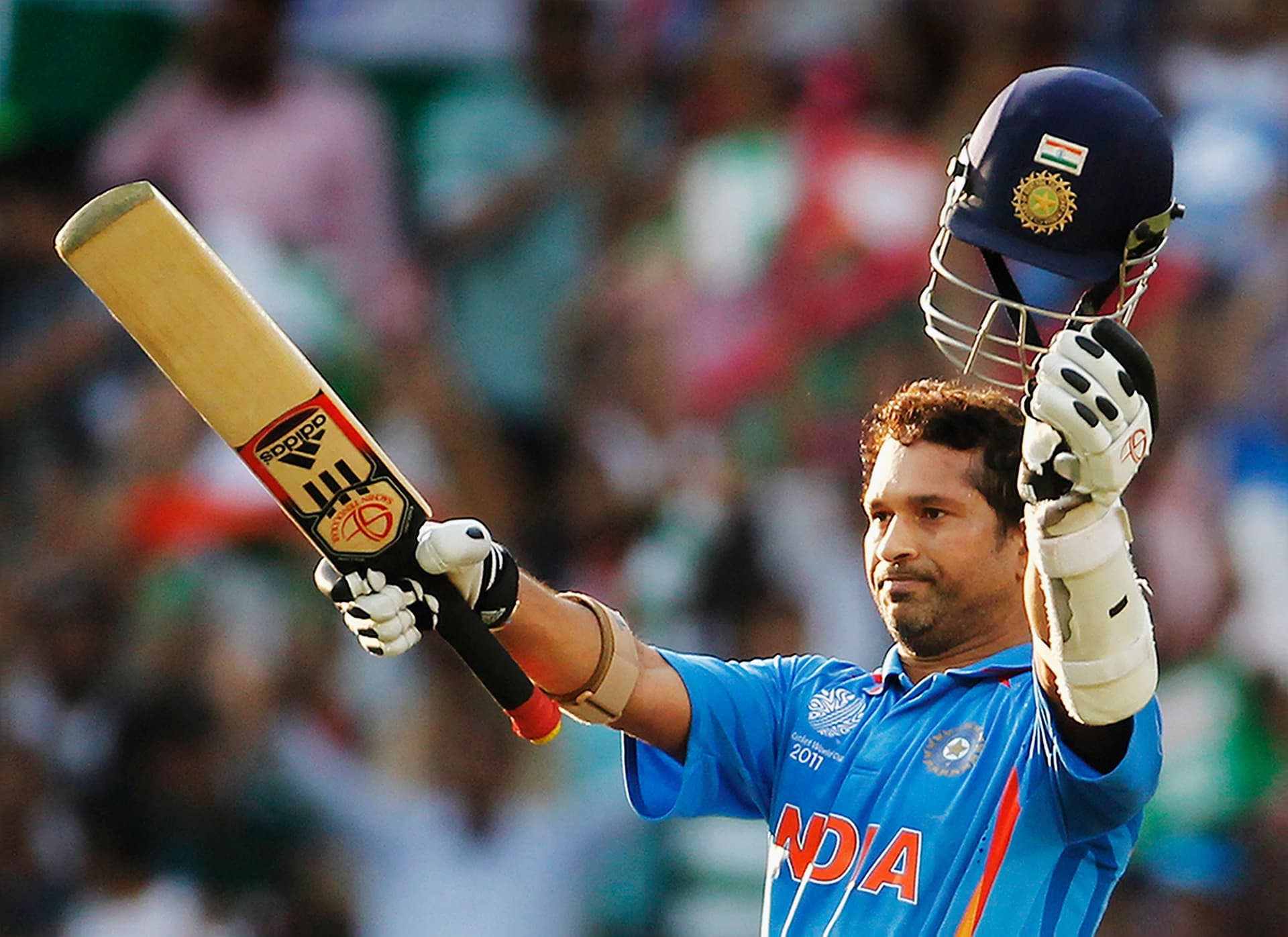 Sachin Tendulkar of India raises his bat on scoring his century during the Group B ICC World Cup Cricket