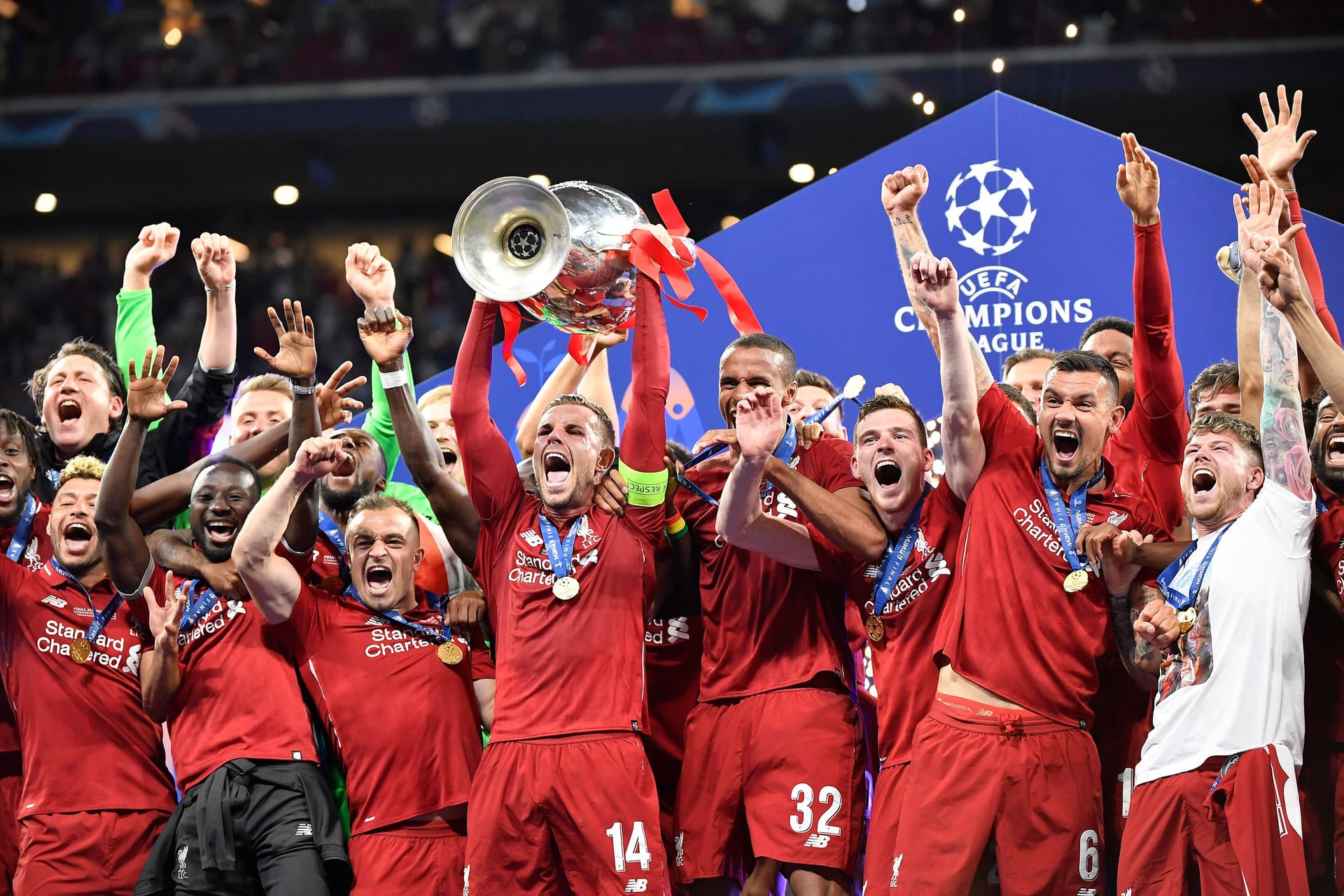 Jordan Henderson of Liverpool FC lifts the trophy with his teammates as they celebrate winning the UEFA Champions League Final